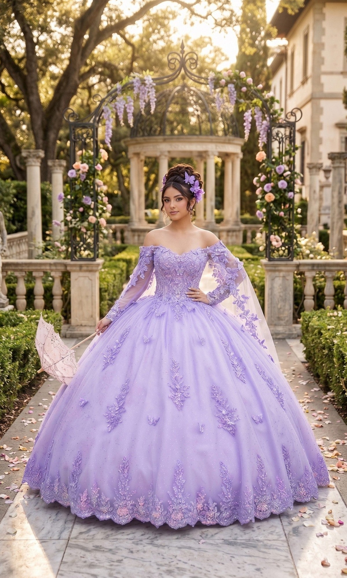 A woman wearing the Quinceanera Dress CHF3121 by Chicas in lilac stands in a garden, surrounded by flowers and columns, holding a lace parasol.