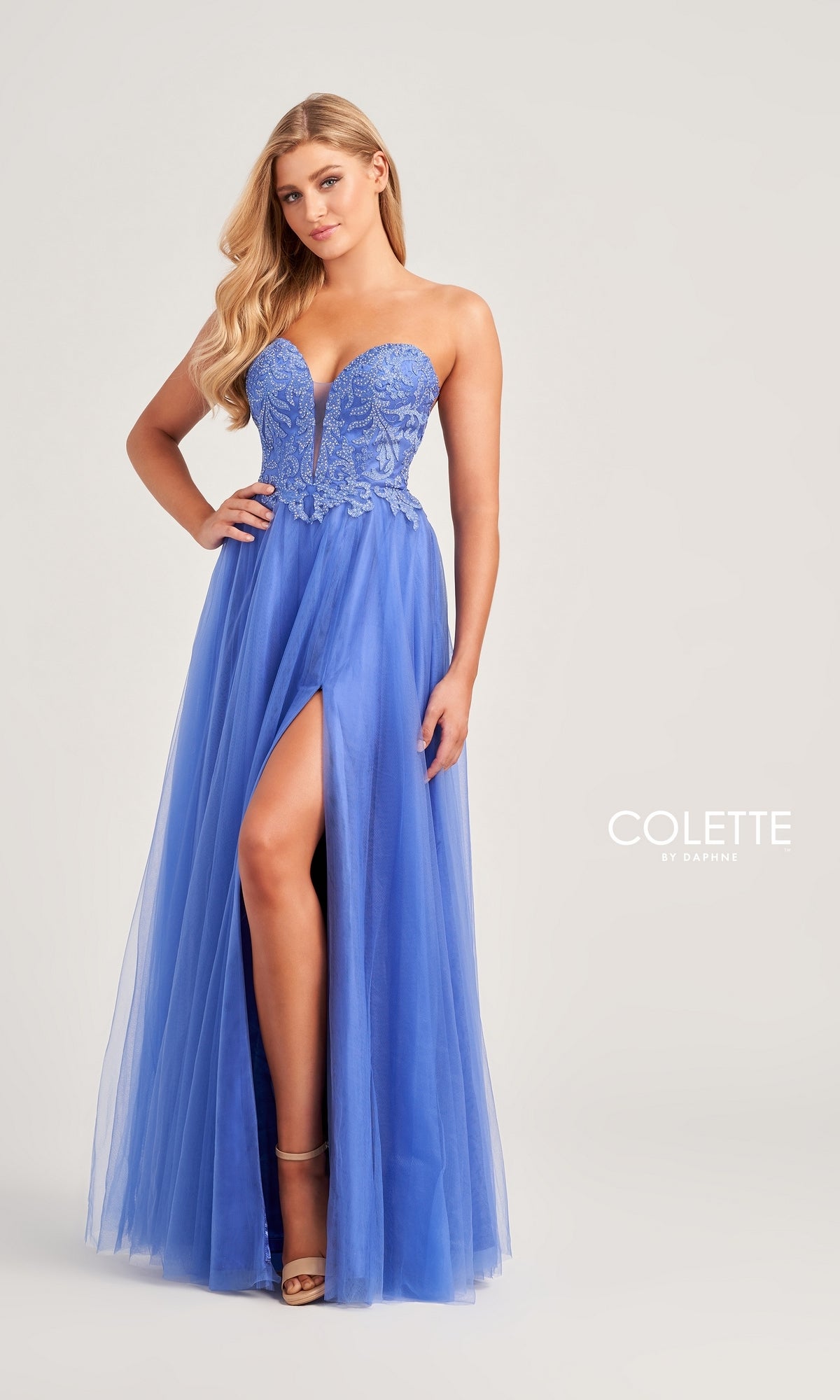 A woman poses against a plain background wearing the Colette Strapless Long A-Line Prom Dress CL5132, featuring a sweetheart neckline, embroidered bodice, and high leg slit.