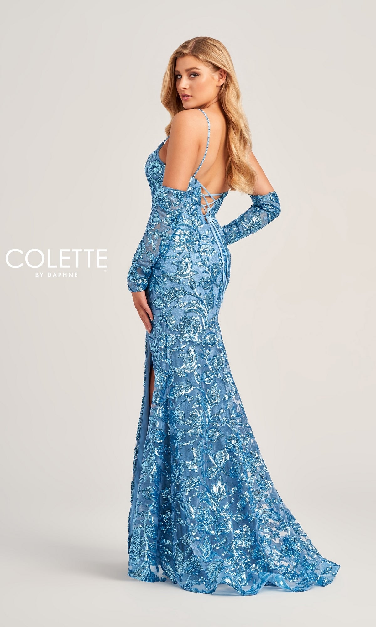 A woman in profile wears the Colette Long Sequin Prom Dress CL5264 with Gloves—a fitted, floor-length blue gown featuring thin straps, a side slit, and matching long gloves—against a plain background.