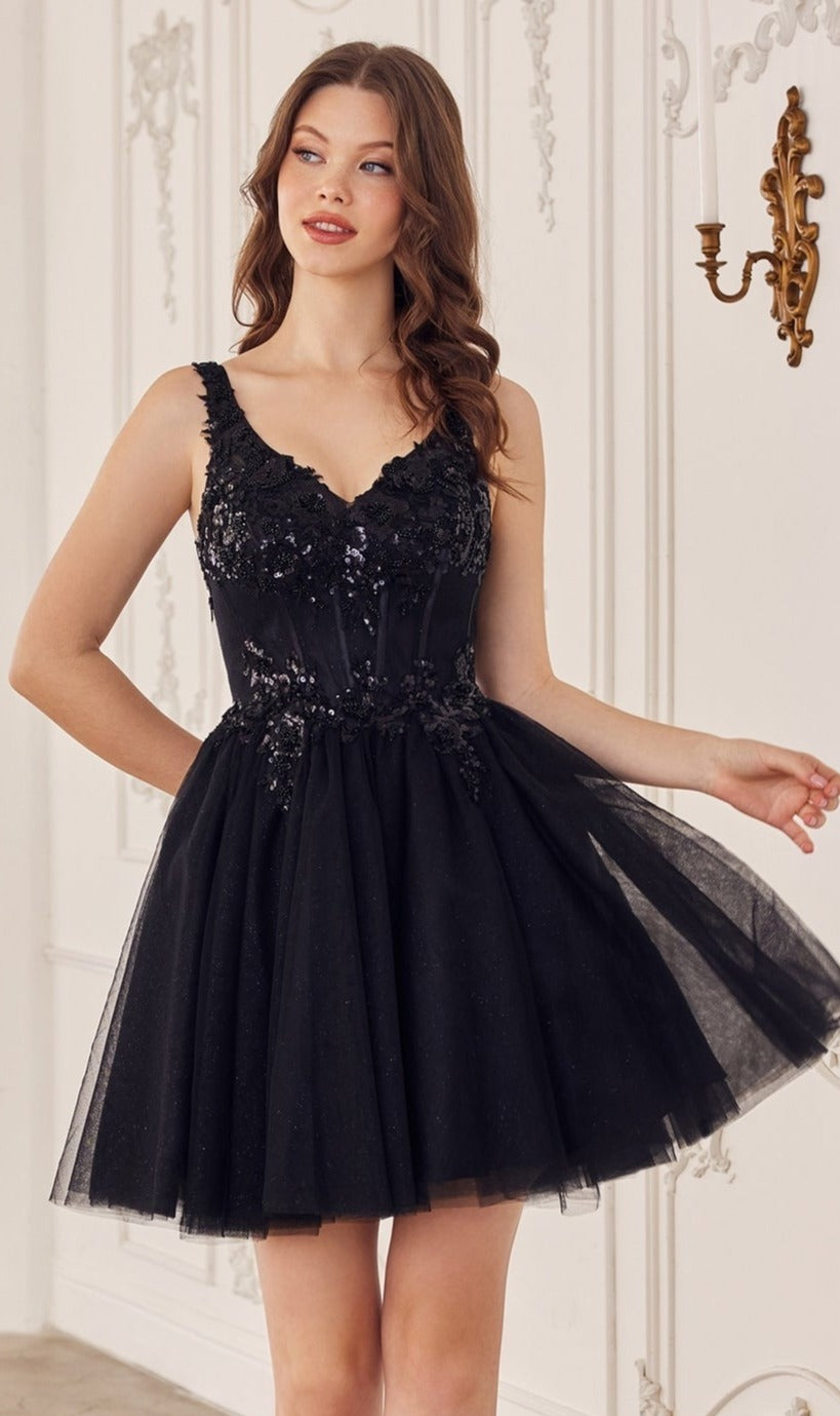 A woman in the Sequin-Corset Short A-Line Homecoming Dress CY019—a sleeveless black dress with sequin details and a flared tulle skirt—stands in an ornate white room.