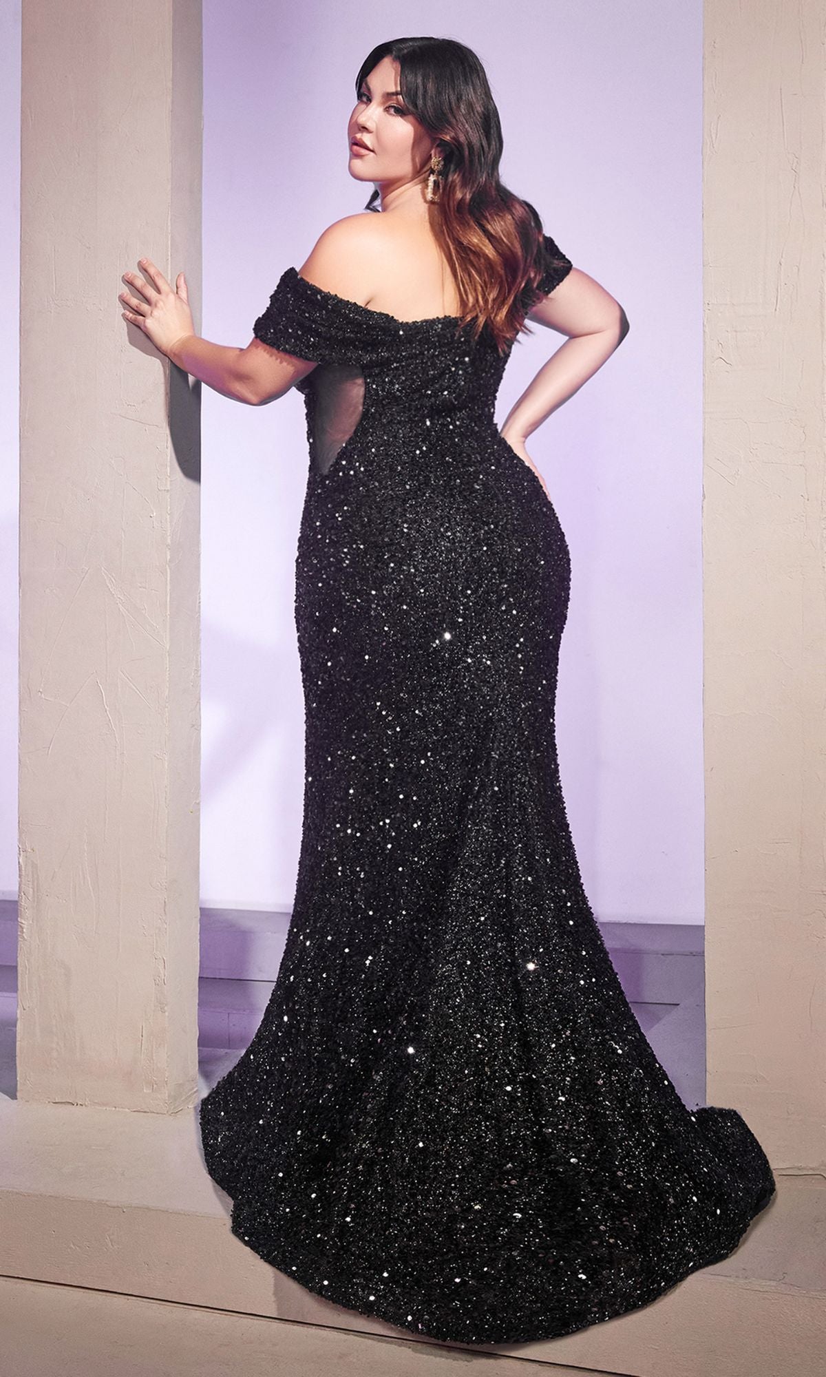 A woman poses between columns, glancing over her shoulder in the Plus-Size Sequin Mermaid Prom Dress CD975C.