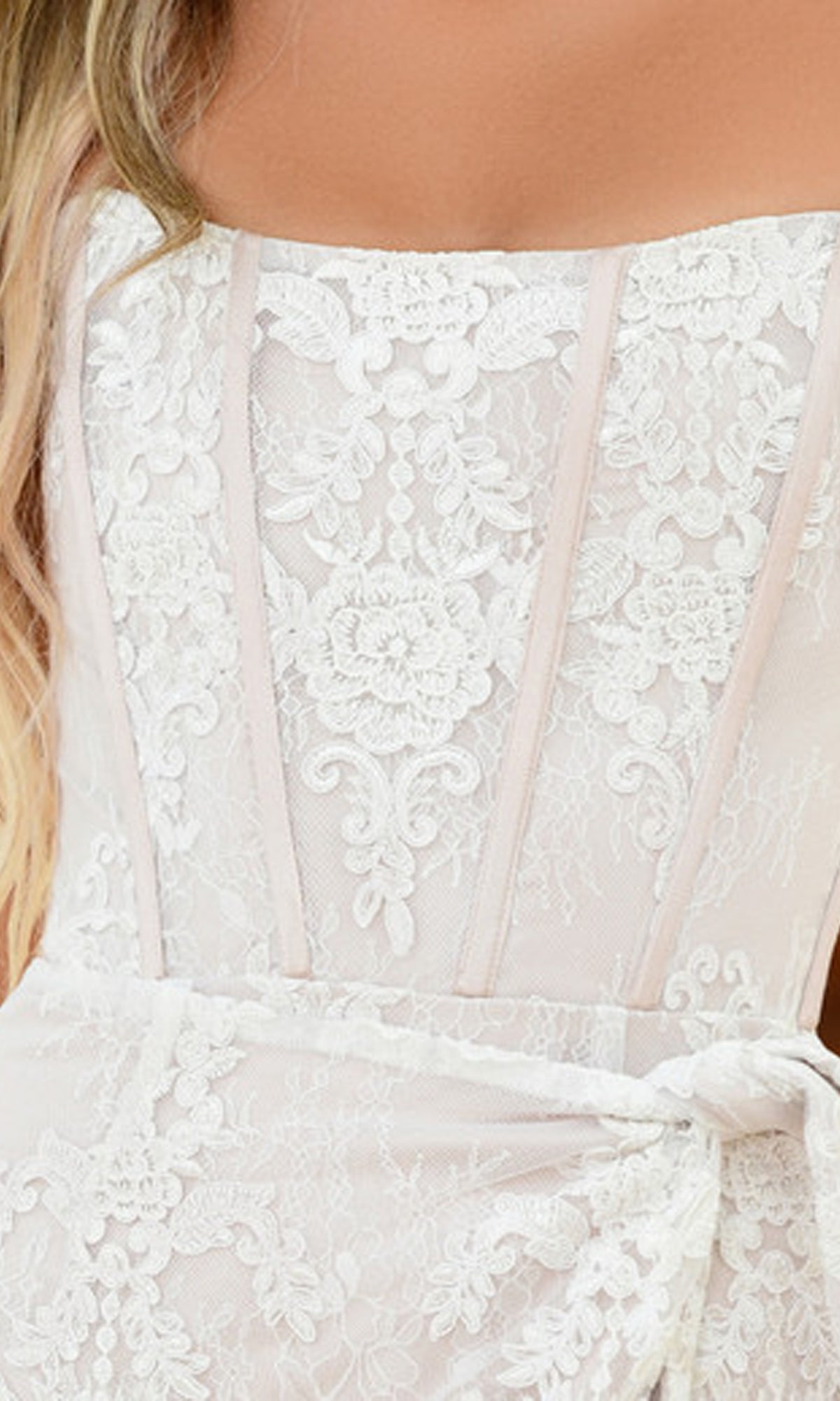 Close-up of a woman wearing the Everly Strapless Ivory Lace Graduation Party Dress, featuring floral patterns, visible boning, and a strapless neckline for a chic, elegant look.