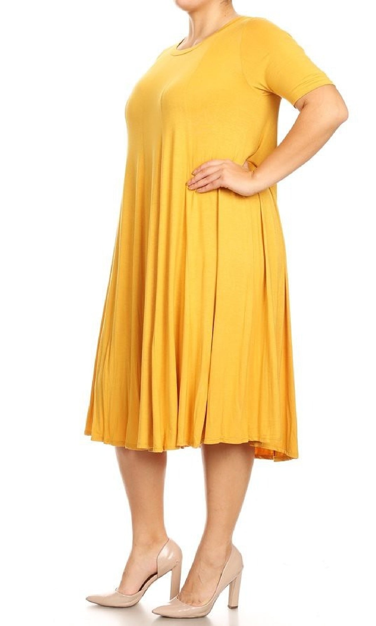 A person stands in side view wearing the Plus-Size Jersey Knit Oversized A-Line Casual Dress in yellow with short sleeves and knee-length fit, paired with beige high-heeled shoes.
