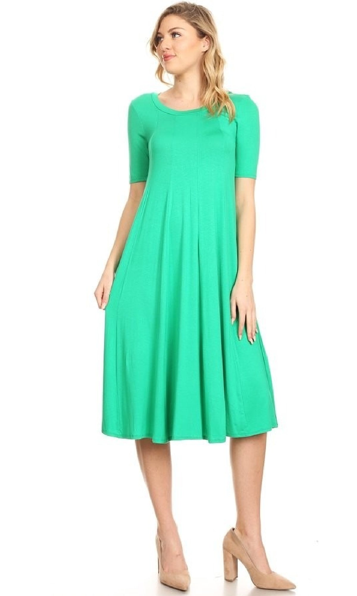 A woman wearing a bright green Short Sleeve Casual Oversized Jersey Knit Dress and beige heels stands against a plain white background.