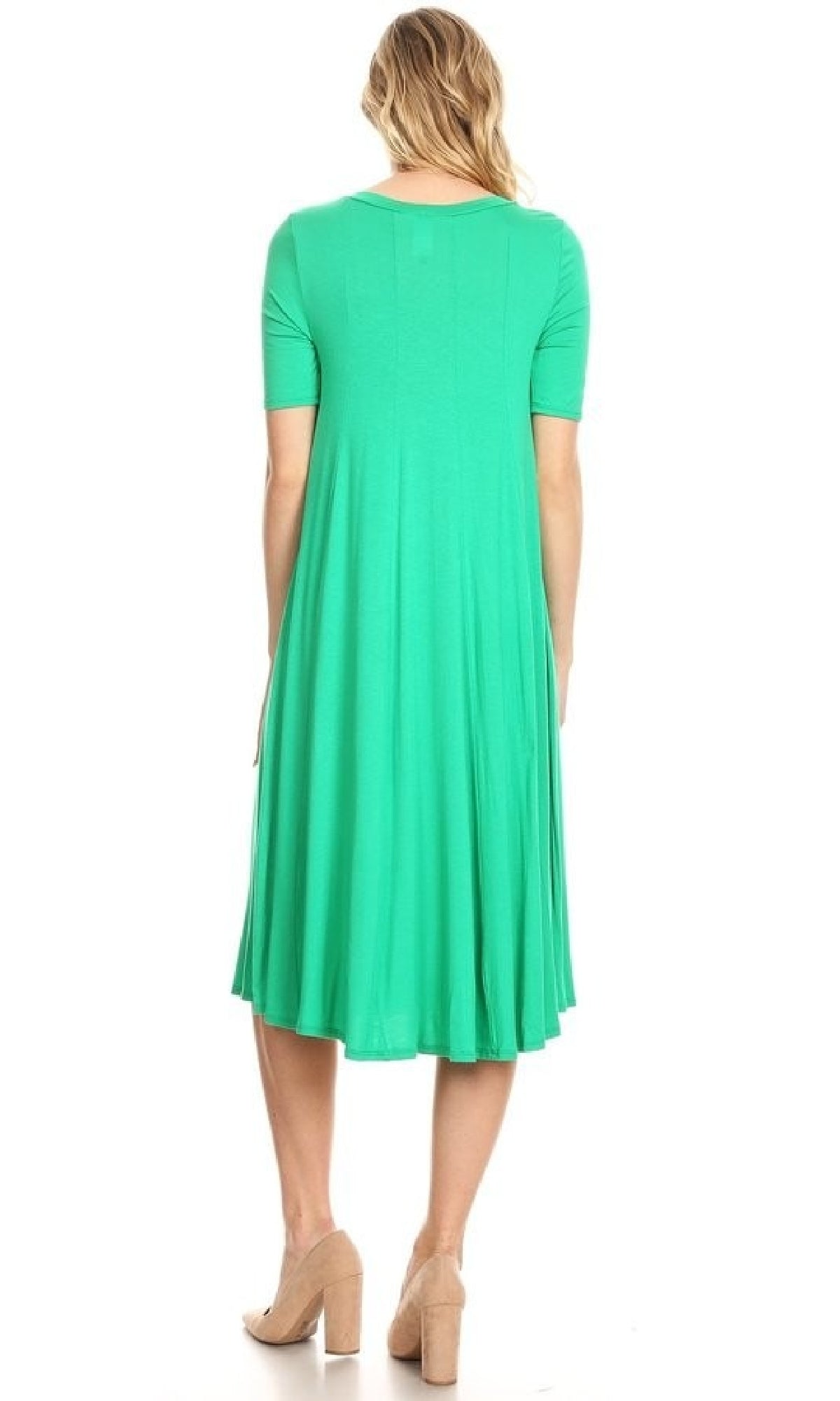 A woman faces away, wearing a knee-length bright green Short Sleeve Casual Oversized Jersey Knit Dress and beige heels.
