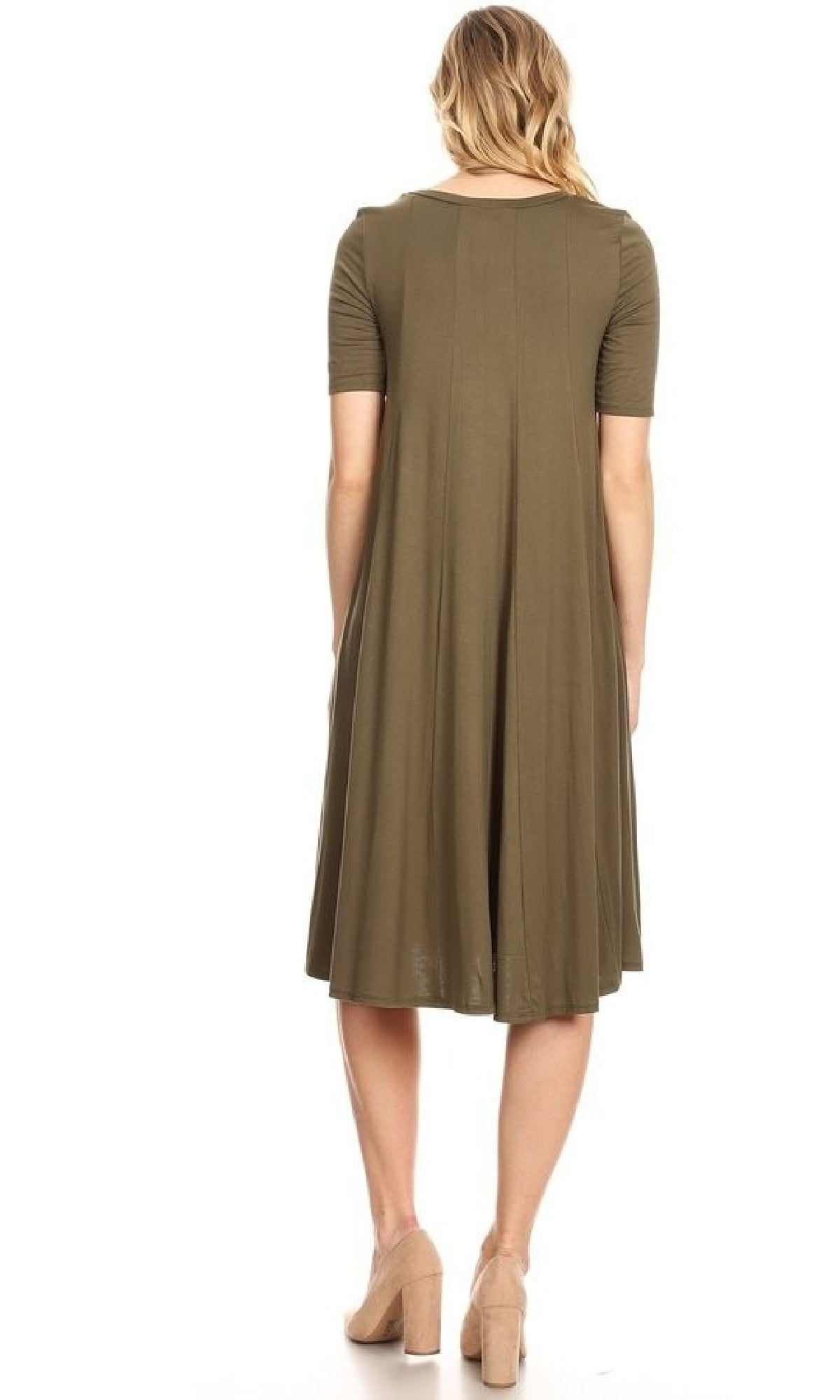 A woman faces away, wearing the Short Sleeve Casual Oversized Jersey Knit Dress in olive green, knee-length with short sleeves, paired with beige block-heel shoes against a white background.
