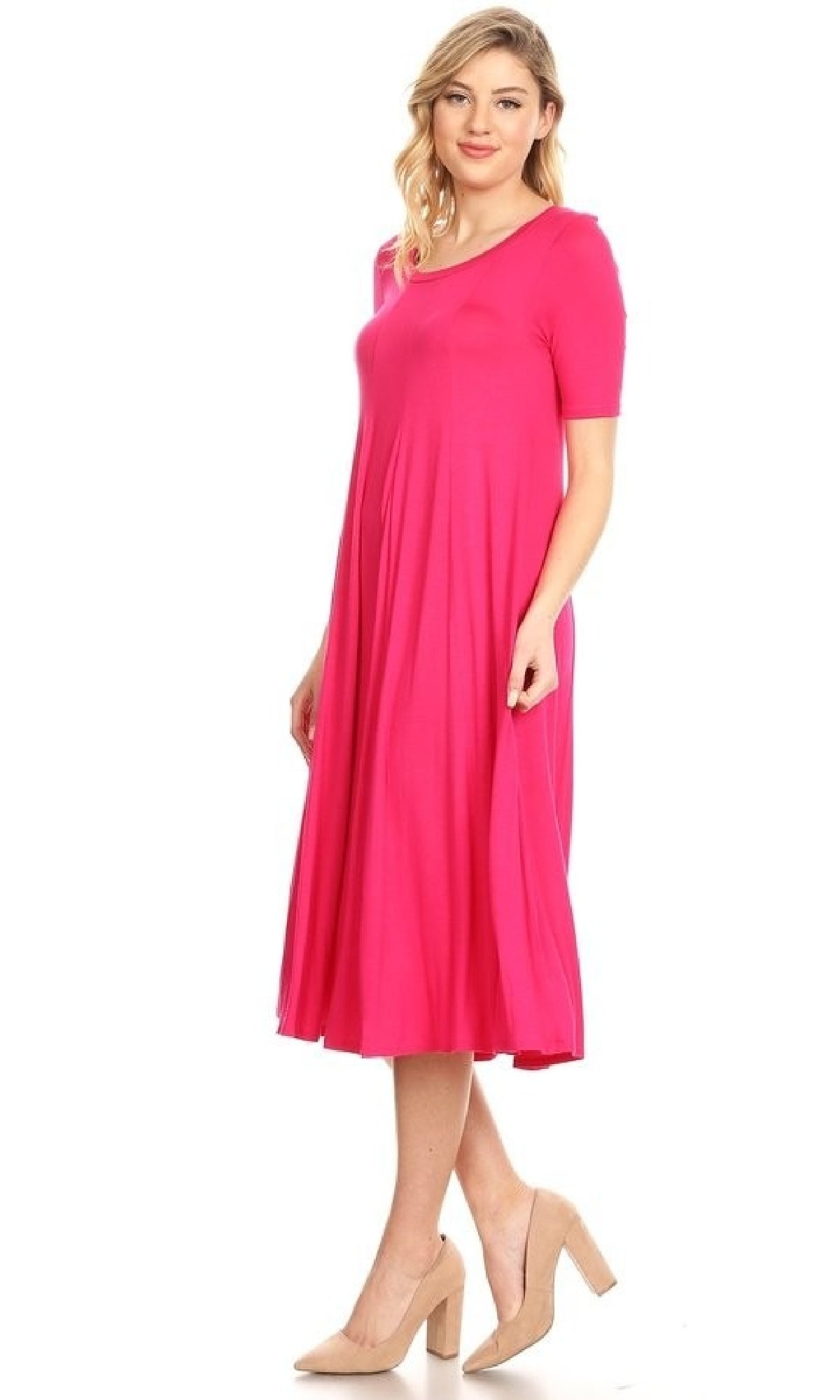 A woman stands against a white background wearing the Short Sleeve Casual Oversized Jersey Knit Dress in bright pink with nude heels.