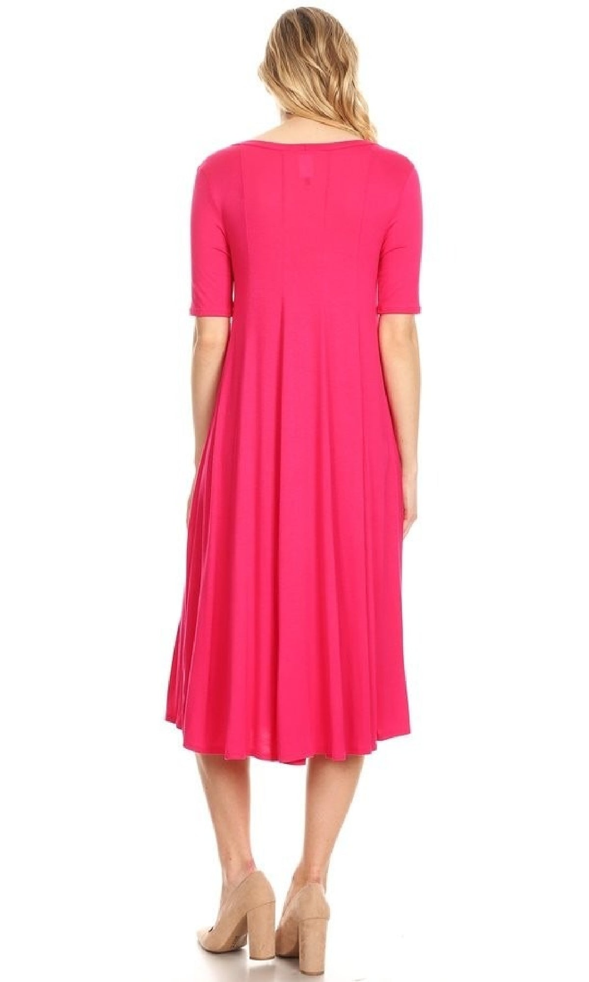A woman stands facing away against a white background, wearing the Short Sleeve Casual Oversized Jersey Knit Dress in bright pink with short sleeves and tan block-heeled shoes.
