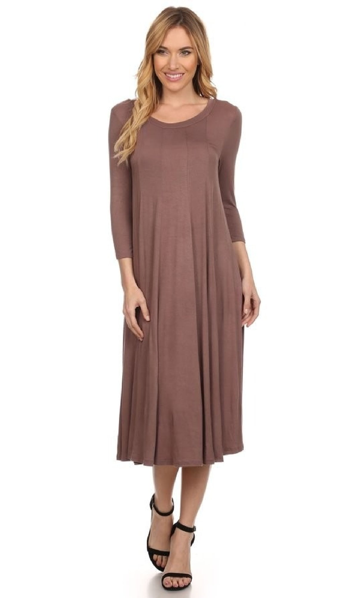 A woman models the Knee-Length Casual Party Dress with long sleeves and a round neckline, paired with black sandals, against a white background.