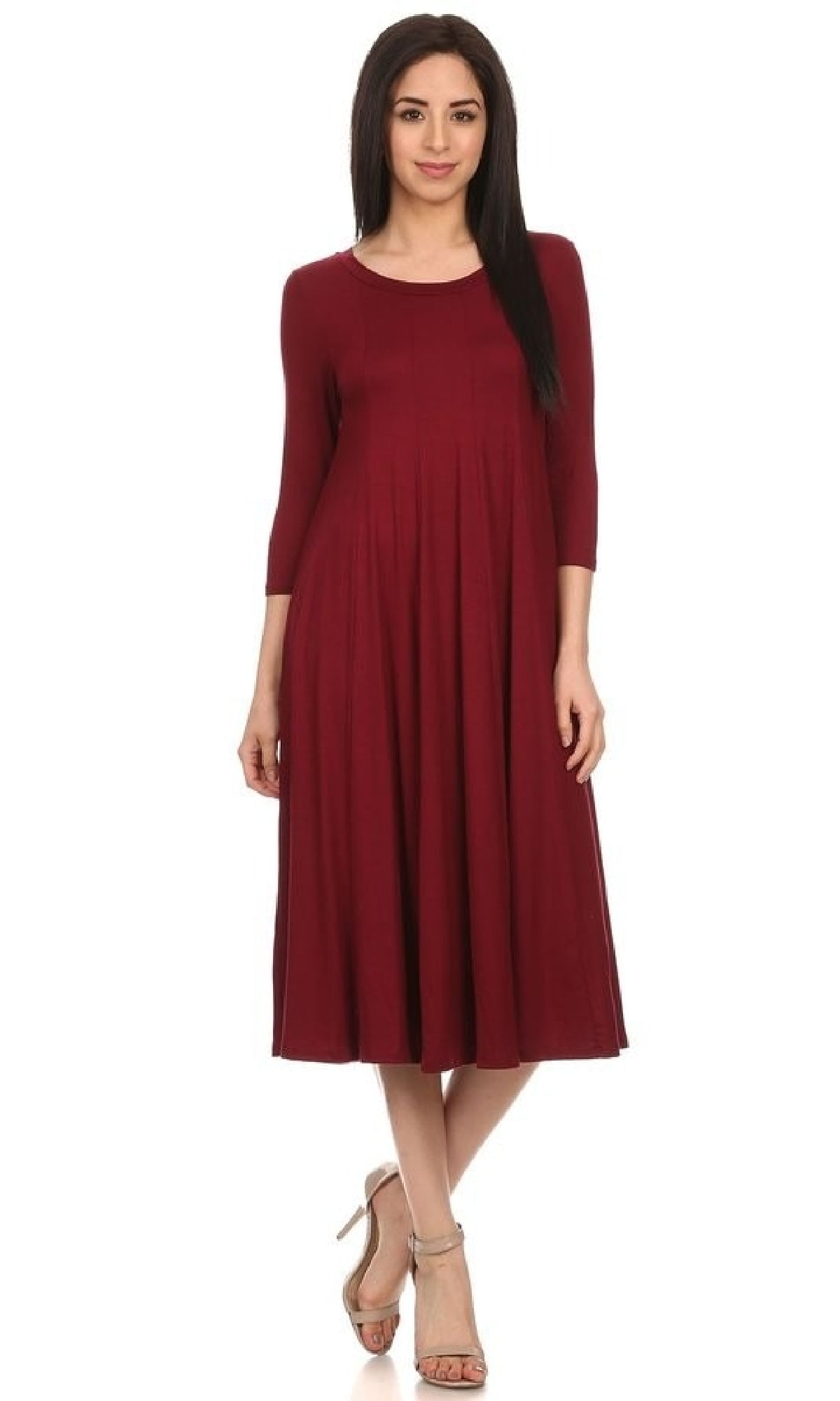 A woman wearing the Knee-Length Casual Party Dress in maroon with long sleeves and beige heels stands against a white background.