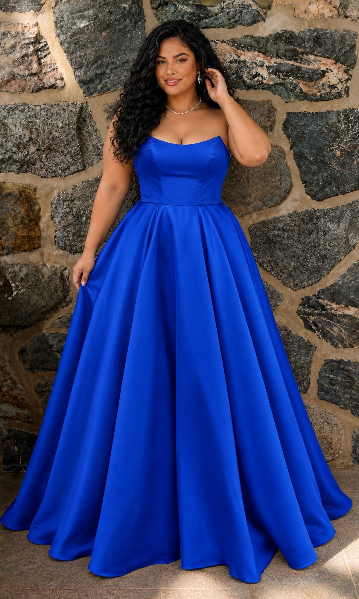 A person wearing a Long Plus-Size Prom Dress: Faviana E11670E, a strapless, floor-length royal blue mikado A-line gown with a full skirt.