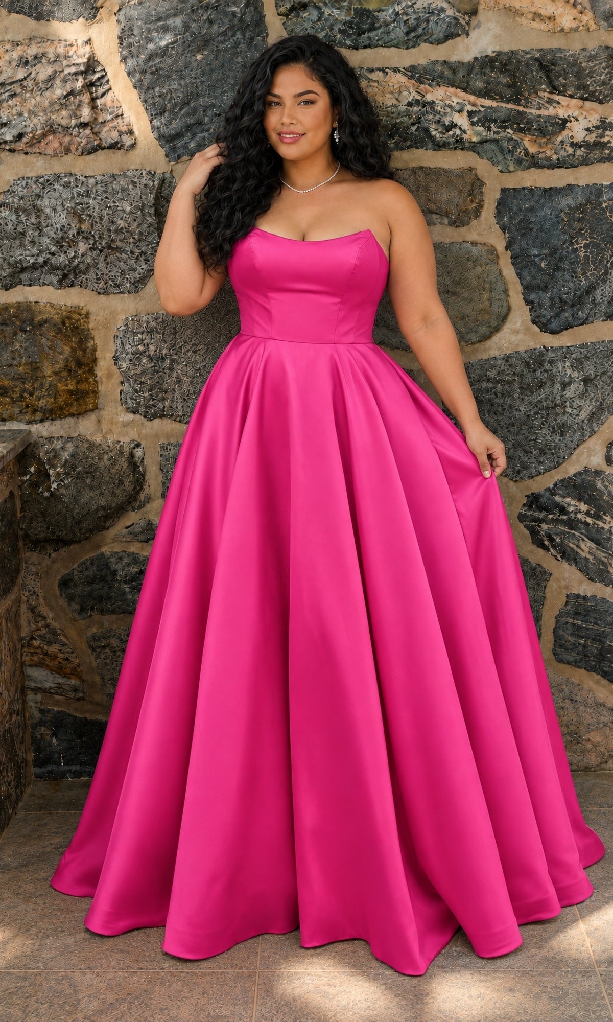 A person wears a strapless, floor-length Wild Berry mikado A-line gown with a full skirt, the Long Plus-Size Prom Dress: Faviana E11670E.