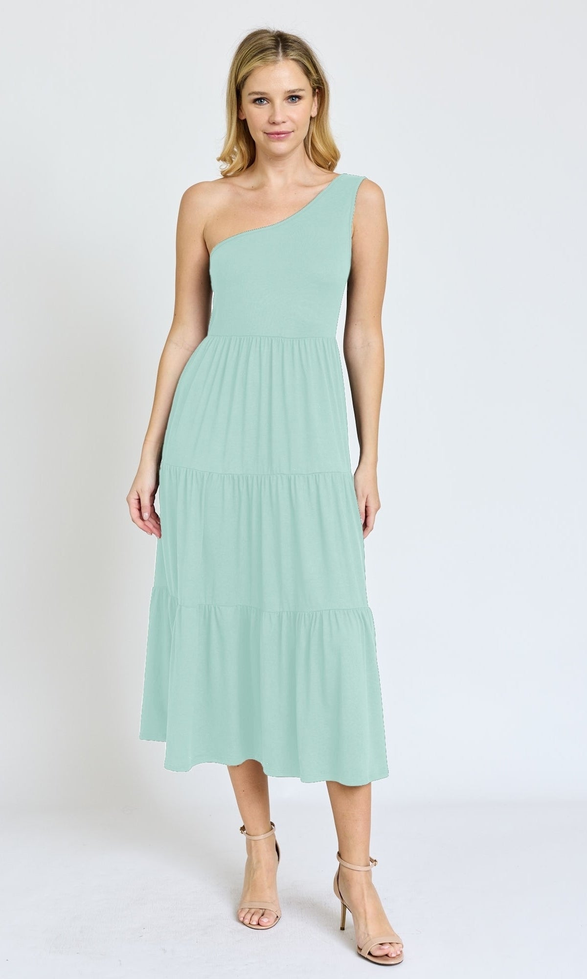 A woman wears the One-Shoulder Casual Everyday Midi Dress in light green with tiered layers and beige heels, standing against a plain white background.