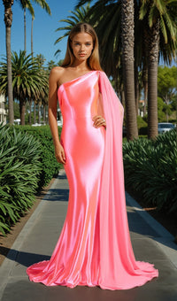 Woman in a pink one-shoulder gown standing on a path with palm trees in the background