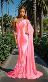 Woman in a pink one-shoulder gown standing on a path with palm trees in the background