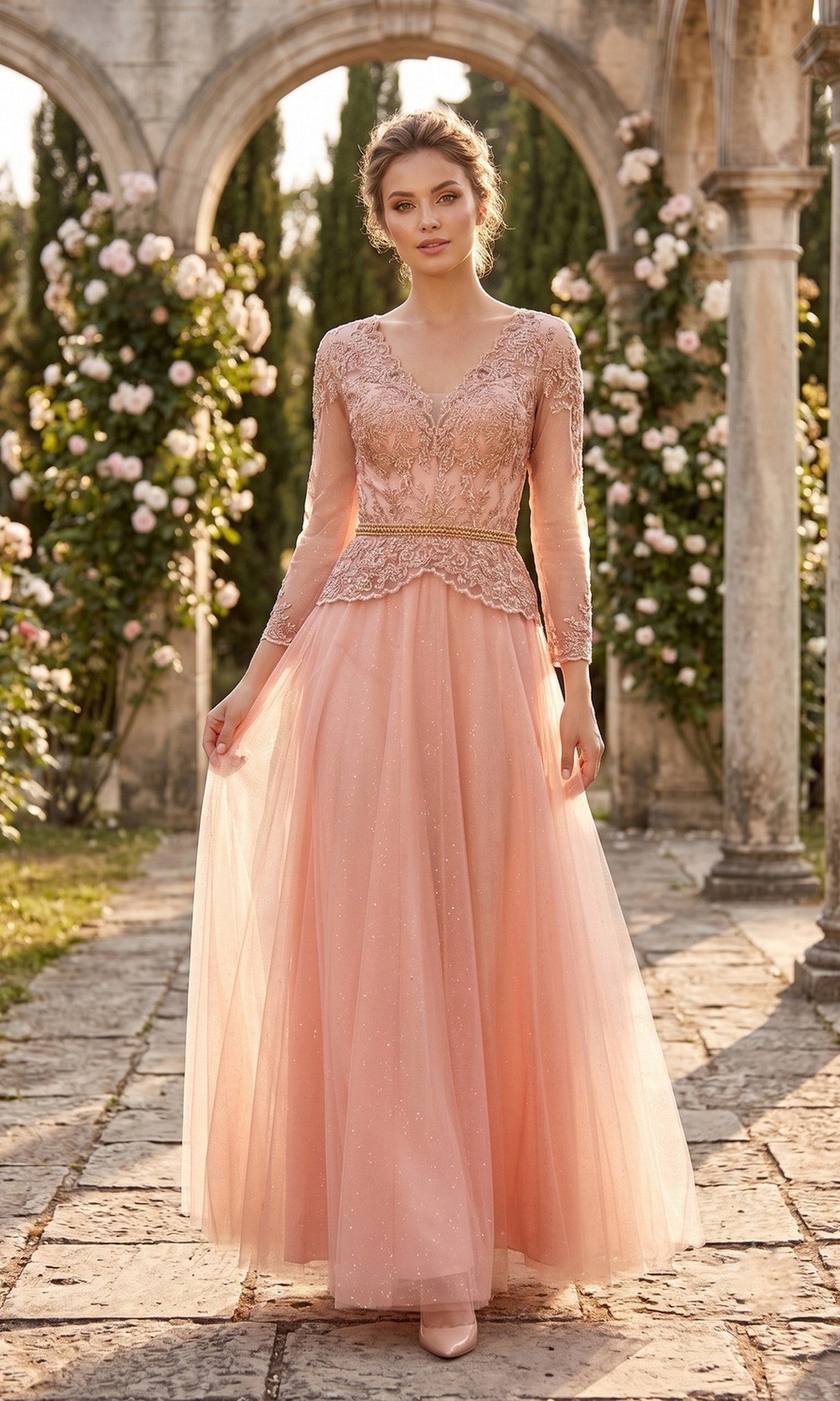 Wearing the Chicas J082 Long Prom Dress in rose, a woman stands on a stone path in a garden surrounded by blooming roses and elegant stone arches—the perfect formal look for the mother of the bride.