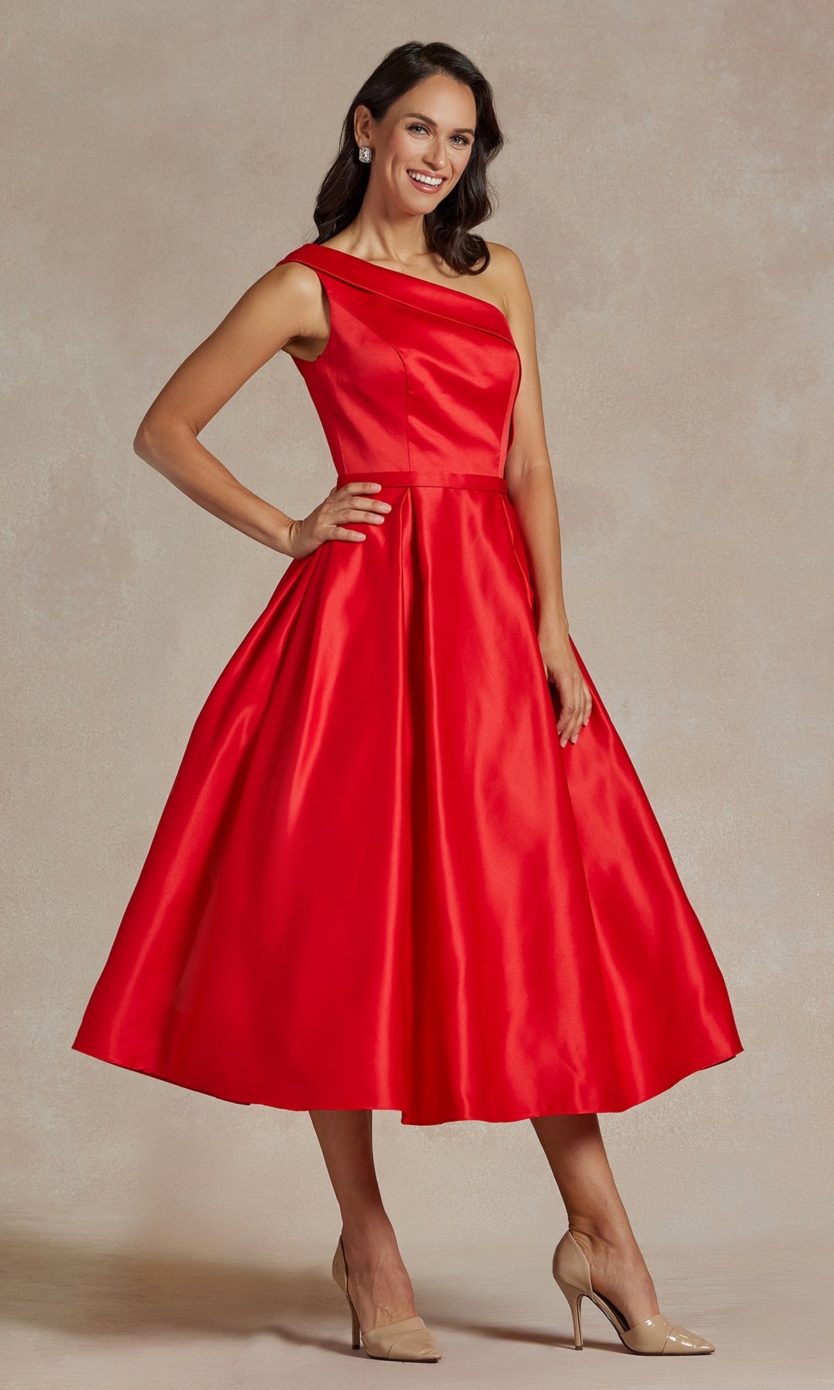 A woman poses against a neutral backdrop wearing the One-Shoulder Simple Tea-Length Party Dress JE931 in bright red, featuring a flared skirt, paired with nude high heels.
