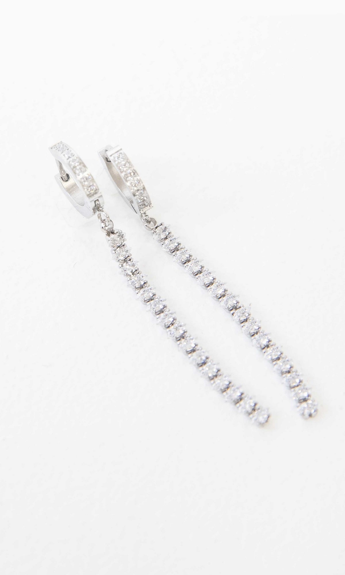 Small Silver Hoop Earrings With Stone Strands featuring long, dangling strands adorned with small clear gemstones.