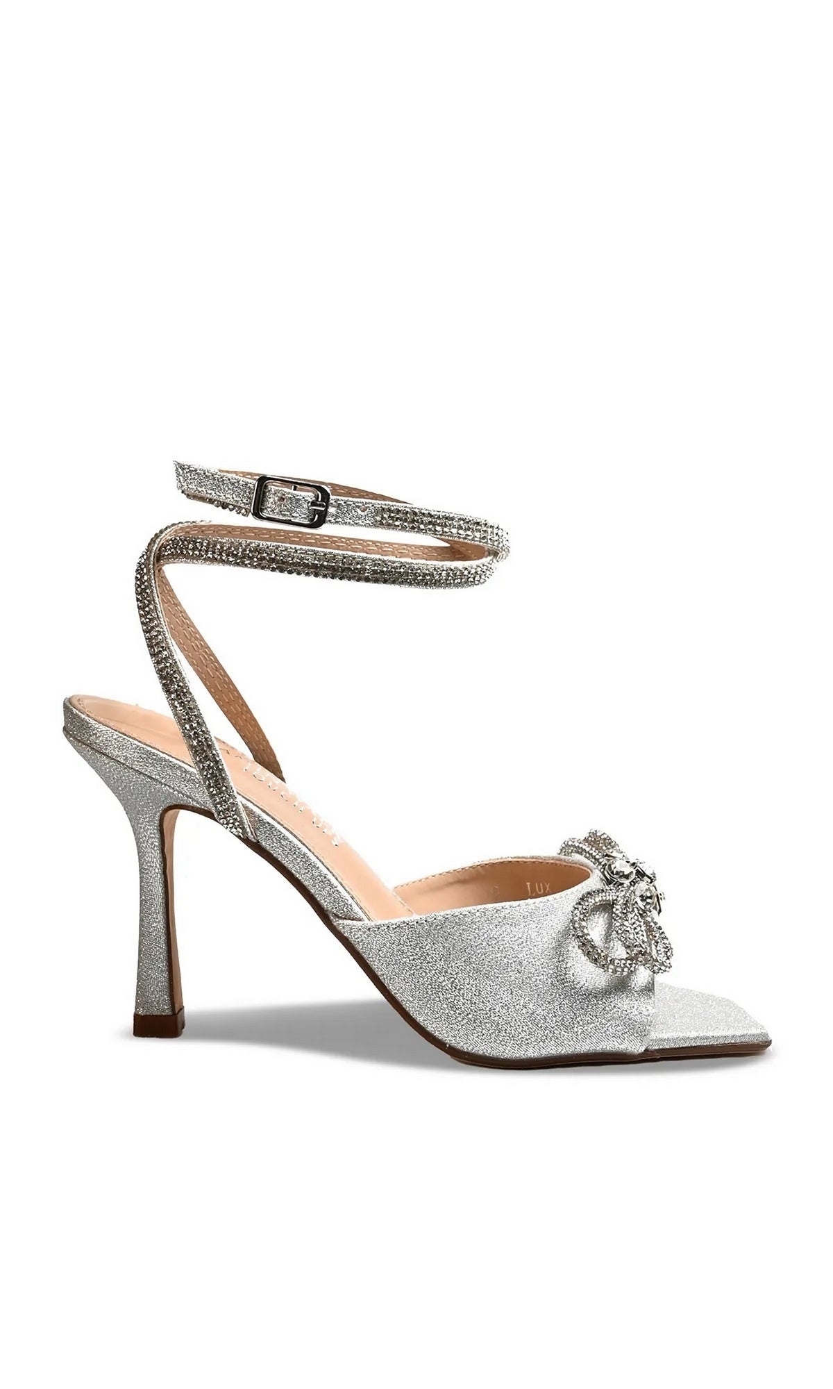 Lux Silver Stiletto Prom Shoes: Touch Ups 4743, a silver glitter stiletto sandal with a rhinestone-embellished bow on the toe and a wrap-around ankle strap.