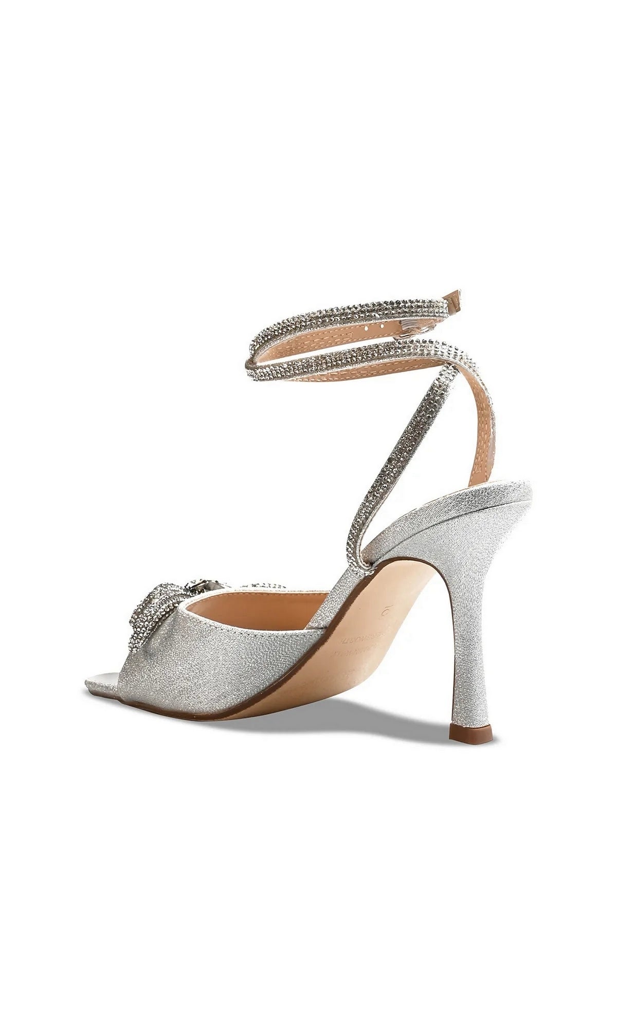 Lux Silver Stiletto Prom Shoes: Touch Ups 4743, featuring a silver stiletto sandal with a crystal-embellished bow at the toe, wraparound rhinestone straps, and a glitter finish.