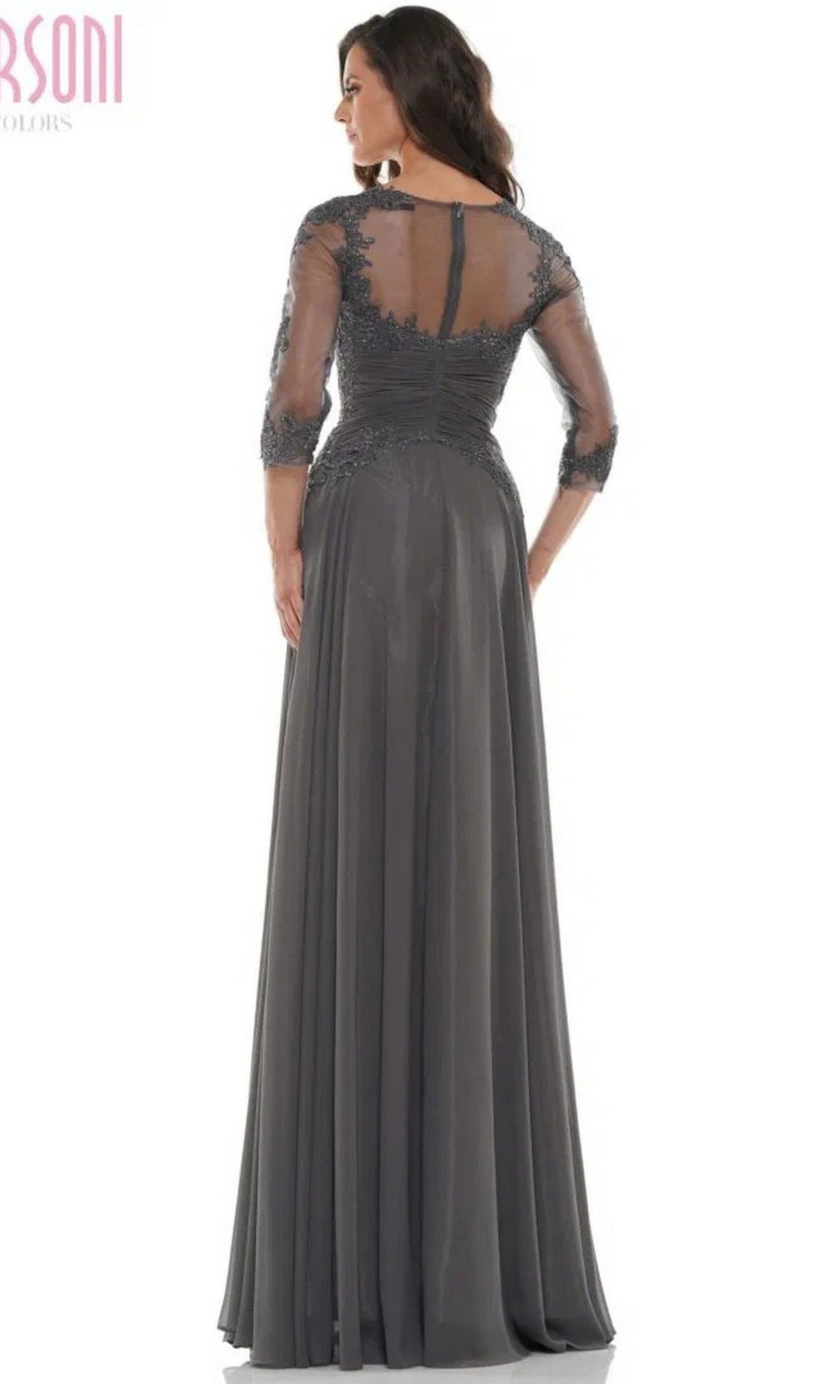 A woman is shown from the back wearing the Marsoni M237, a long formal dress in dark gray featuring an A-line silhouette, sheer three-quarter sleeves, and a lace applique bodice, set against a white background.