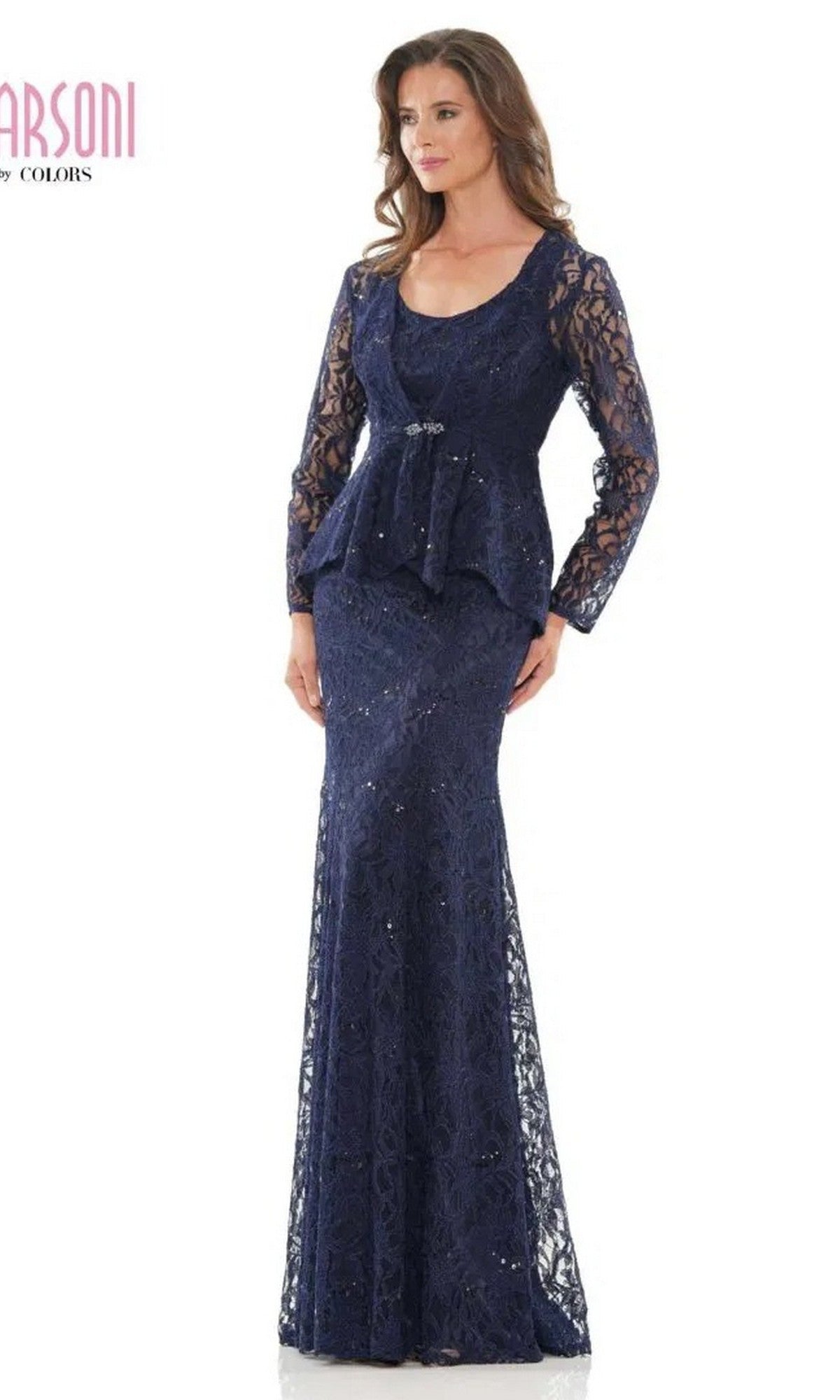 A woman models the Marsoni M301 long formal dress in navy, featuring long sleeves and a peplum waist, standing against a white background.