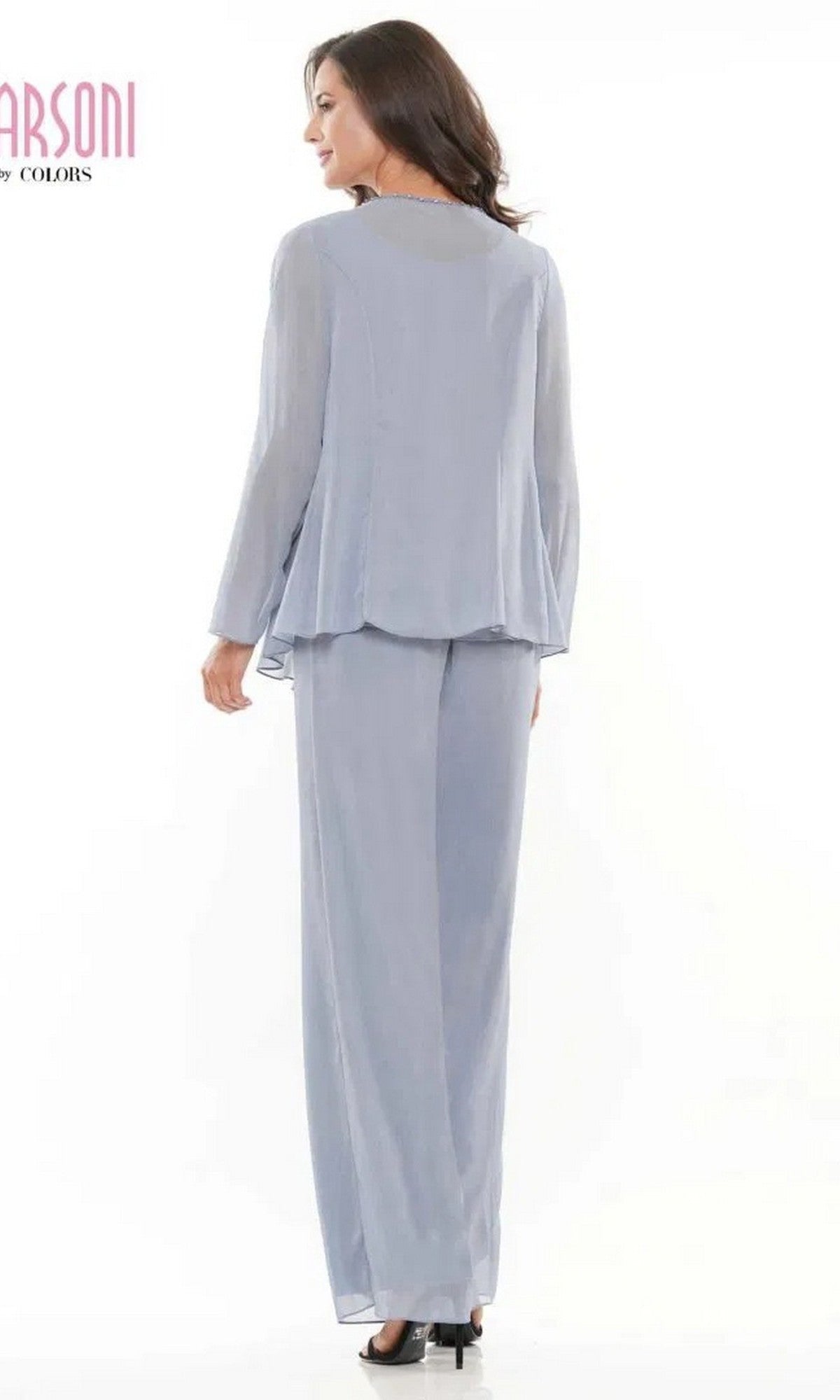 Woman stands facing away in a light blue Marsoni M304 long formal chiffon pantsuit with long sleeves and wide-leg pants, set against a plain white background.