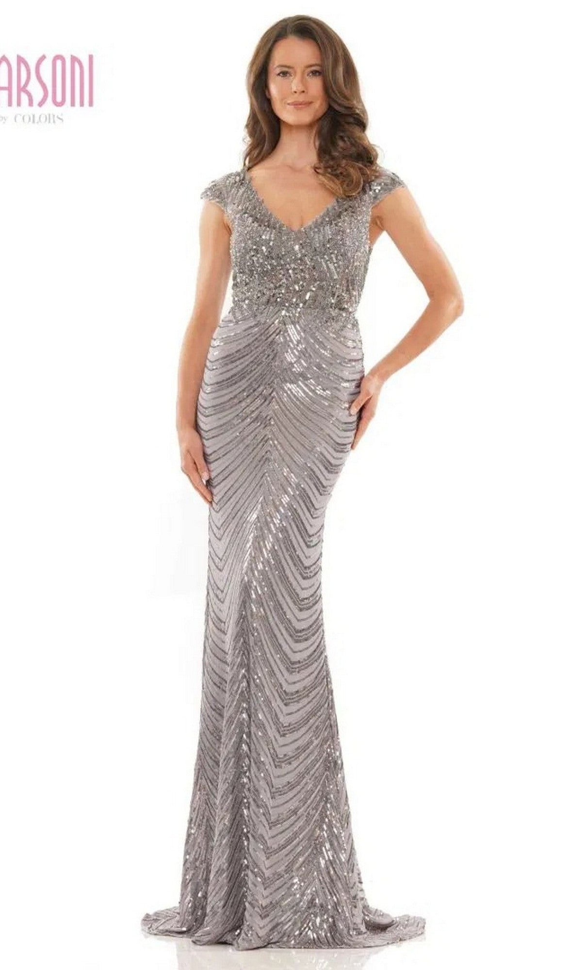 A woman stands facing forward in the Marsoni M315 long formal dress, a floor-length gunmetal gown featuring sequin beadwork, cap sleeves, and a V-neckline.