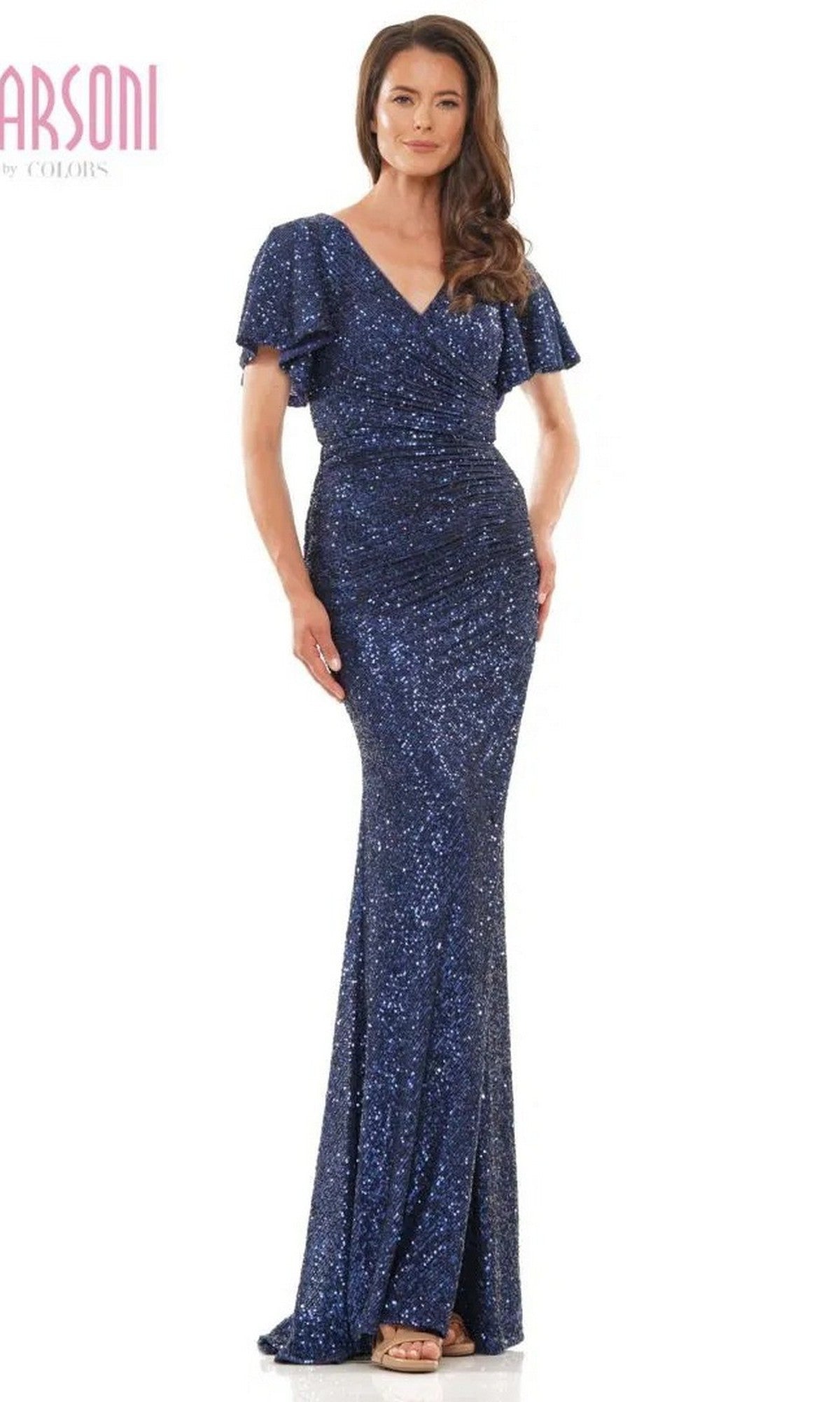 A woman wears the Marsoni M318, a long formal navy dress featuring short flutter sleeves, sequins, and a V-neckline.