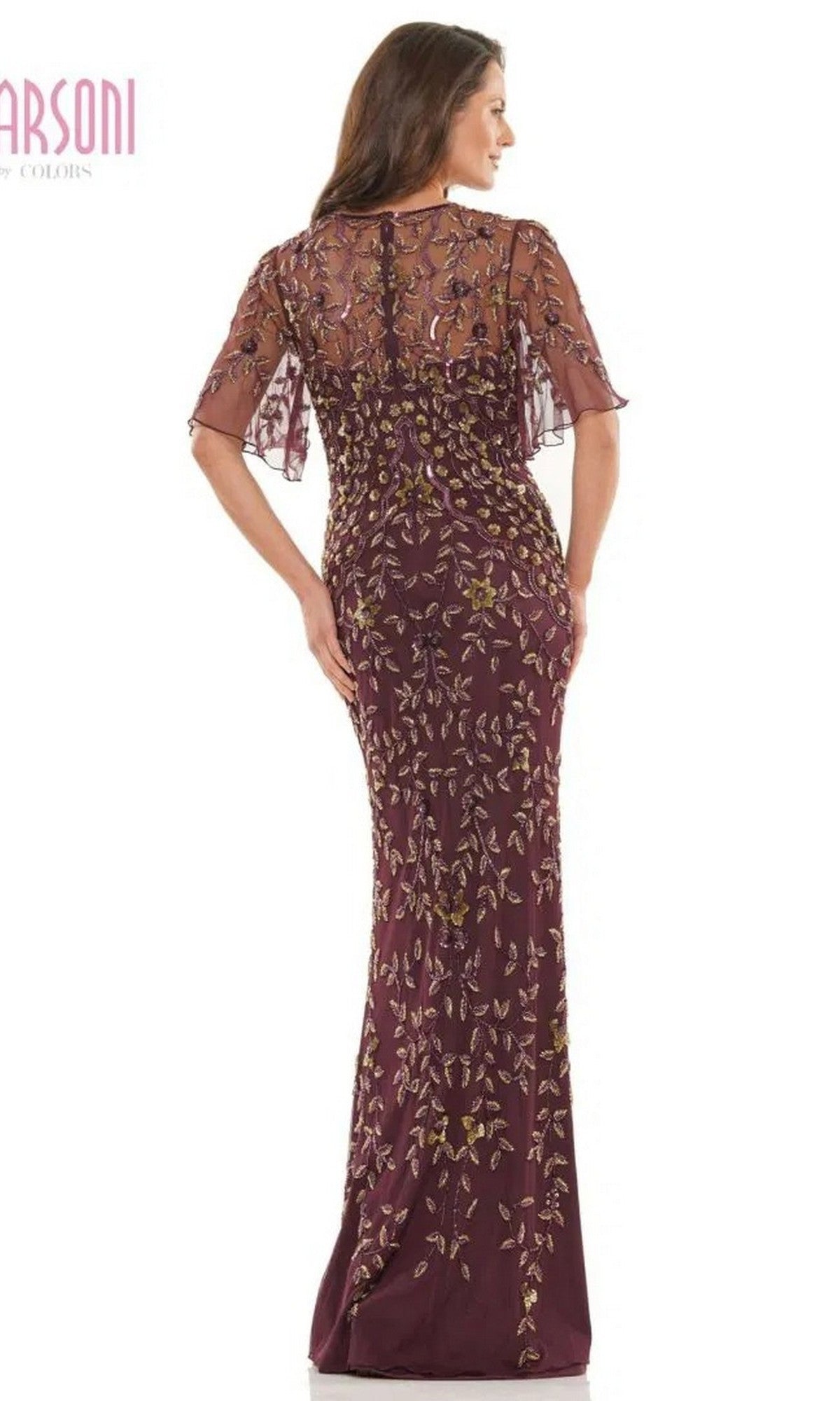 A woman is shown from the back wearing the Marsoni MV1208 long formal dress, featuring a maroon hue, gold and purple floral embroidery, subtle sequin accents, sheer short sleeves, and a fitted sheath silhouette.