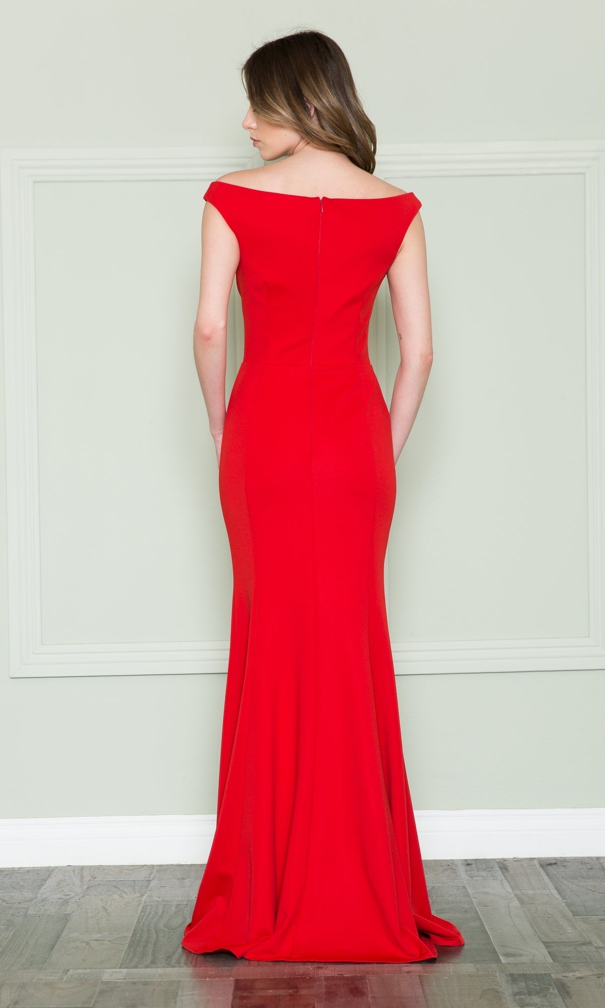 A woman faces away, wearing the Off-the-Shoulder Classic Long Prom Dress 8724 in red, featuring a fitted silhouette, floor-length design, and subtle seam details.