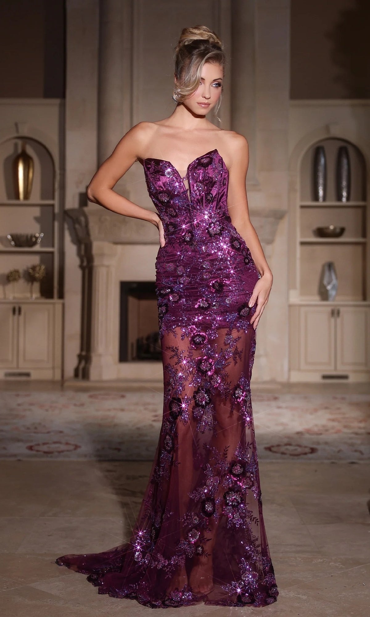 A woman stands indoors wearing the Portia and Scarlett PS25287 long prom dress—a floor-length, purple sequined gown with floral patterns, beaded lace, and sheer sections.