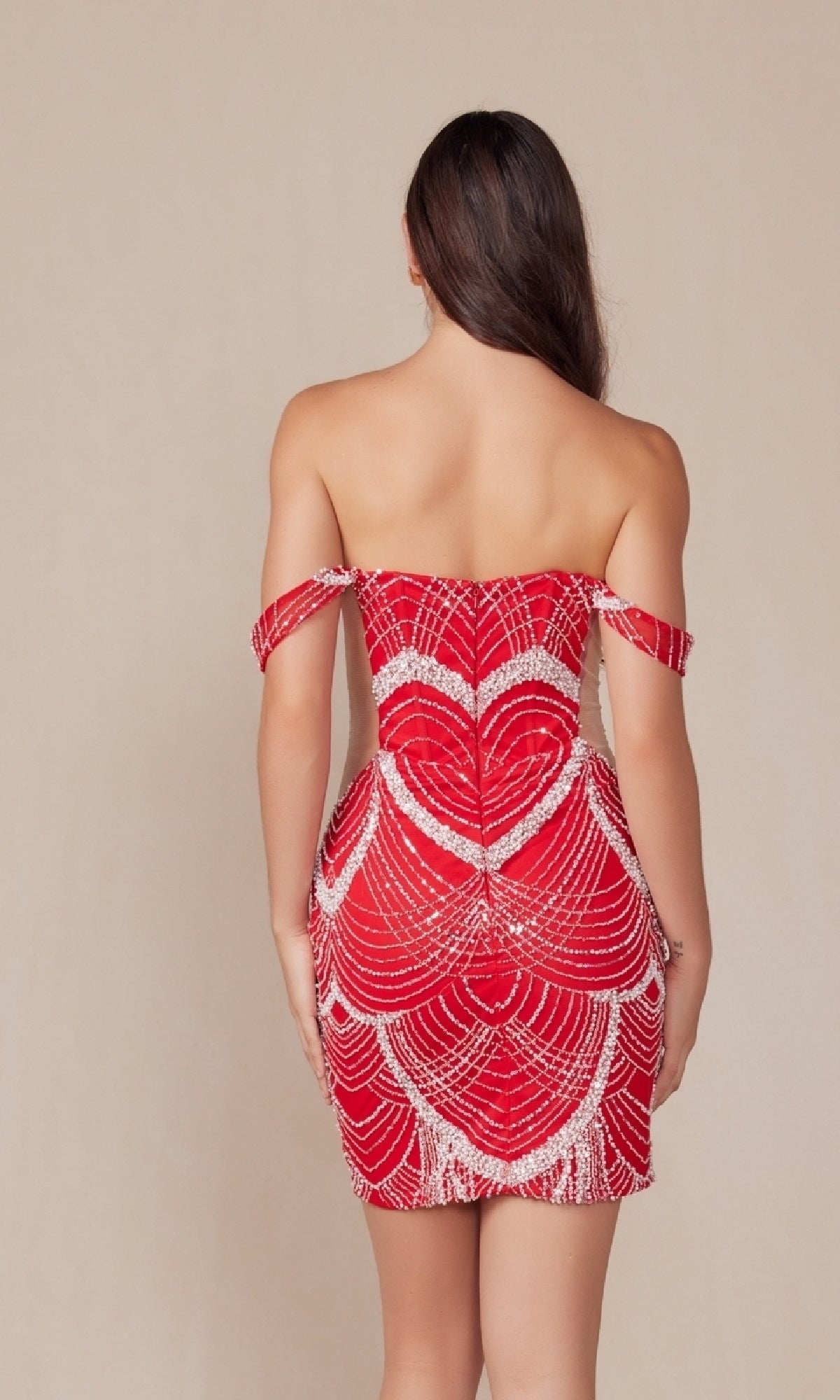 A woman faces away, wearing the Sheer-Sides Short Sexy Homecoming Dress Q839—a form-fitting red cocktail dress with off-the-shoulder style and white geometric bead patterns.