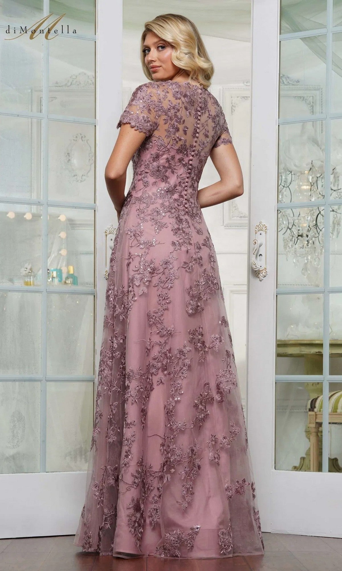 A woman in the Rina Di Montella RD3248 long formal dress featuring a pink hue and an elegant A-line skirt.
