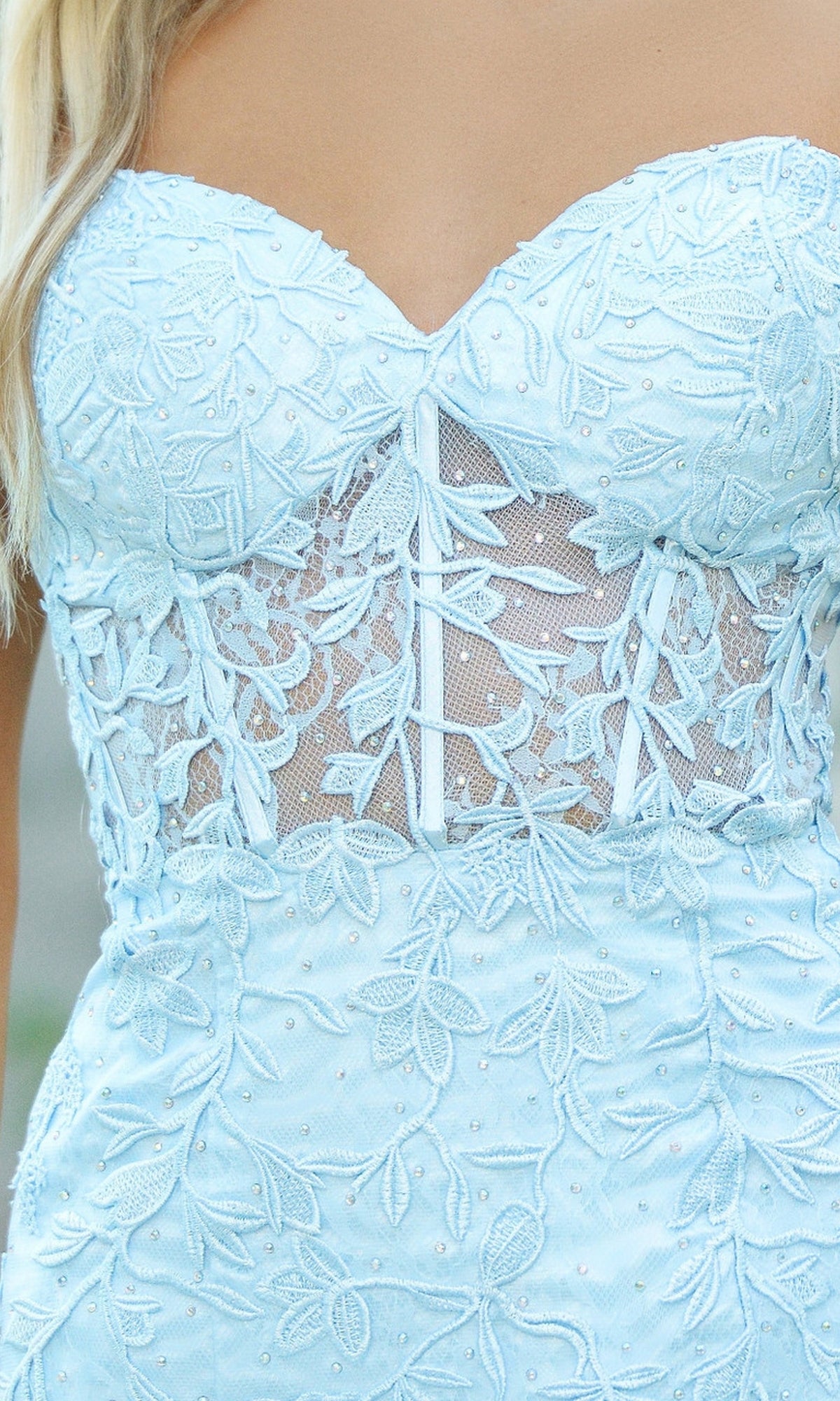 Close-up of the Velvi Strapless Sweetheart Short Party Dress Reva in light blue, featuring floral lace, a sheer mesh midsection, and a strapless neckline—ideal for semi-formal parties.