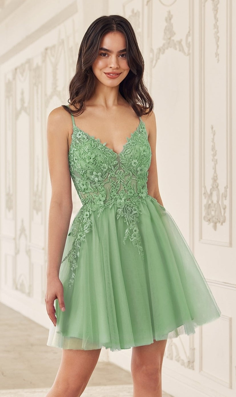 A woman in the Short Babydoll Homecoming Dress: CLSF047, featuring a sleeveless light green embroidered lace bodice and a-line silhouette, stands in an ornately decorated room.