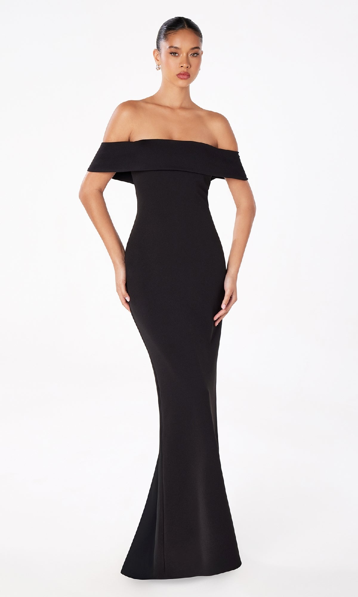 A woman models the Off-the-Shoulder Long Prom Dress: Astee T2011, a floor-length black gown, standing elegantly against a plain white background.