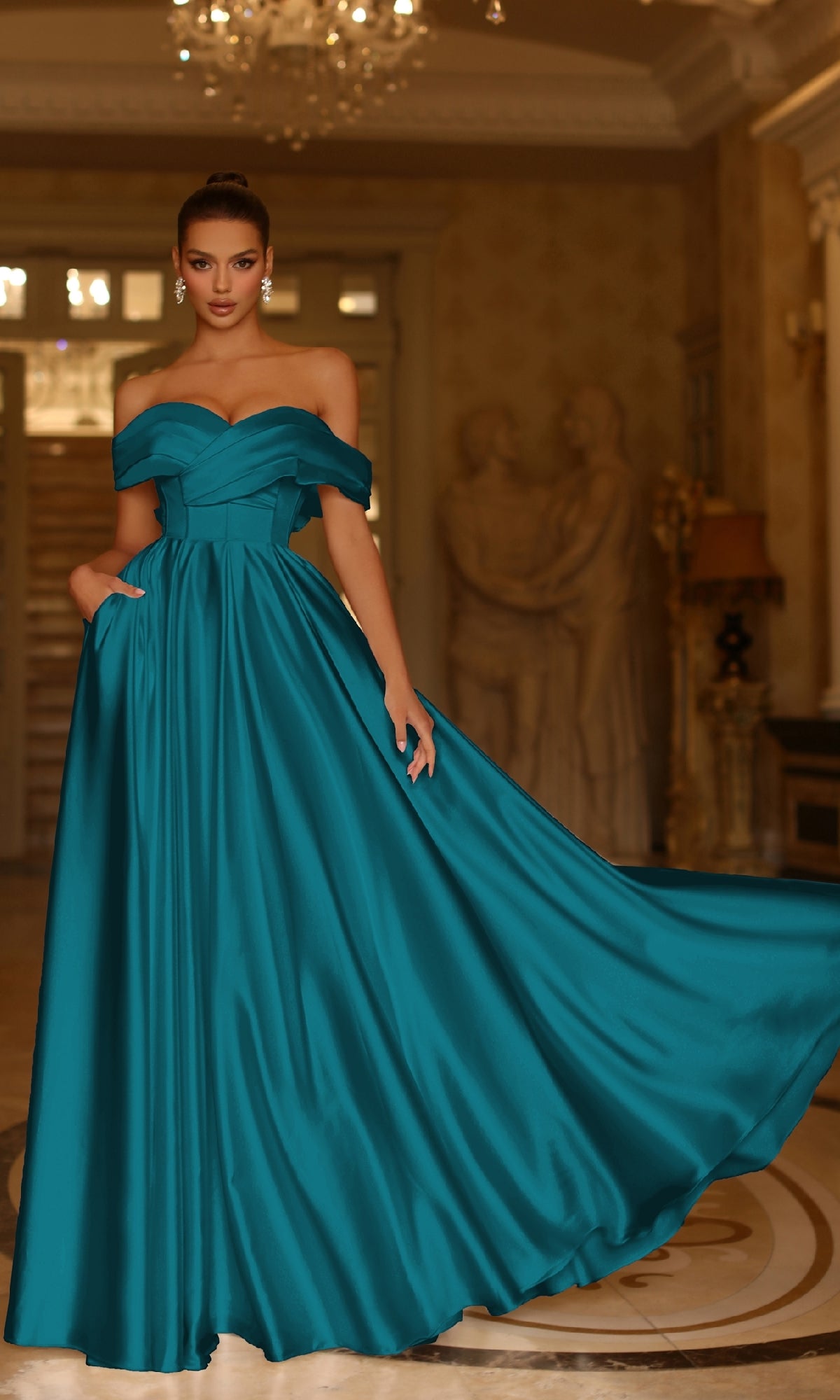 A woman poses indoors in the Bow-Back Long Prom Ball Gown: Tina Holly TE207, gracefully holding the skirt of her floor-length teal off-the-shoulder dress amid elegant decor and statues, highlighting this stunning formal look.