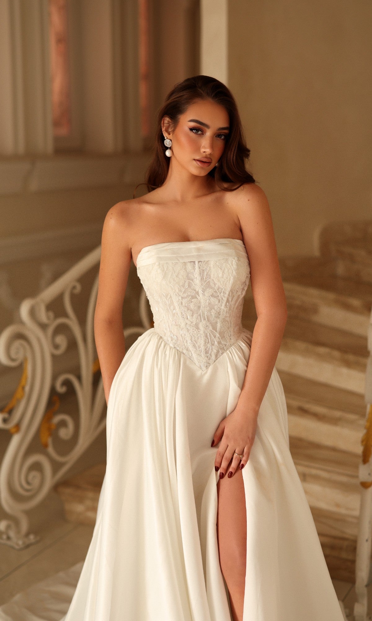 Long Wedding Dress: Tina Holly TE711, a strapless, floor-length A-line wedding dress featuring a lace bodice and a high-leg slit.
