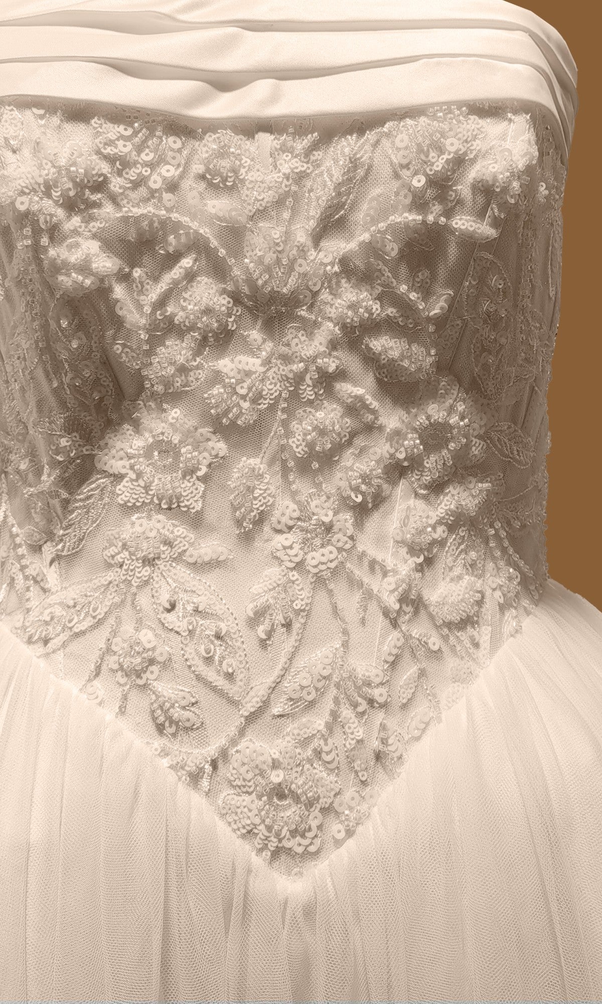 Tina Holly TE713 strapless beaded tulle wedding dress with a floral embroidered bodice featuring beads and sequins over an A-line skirt.