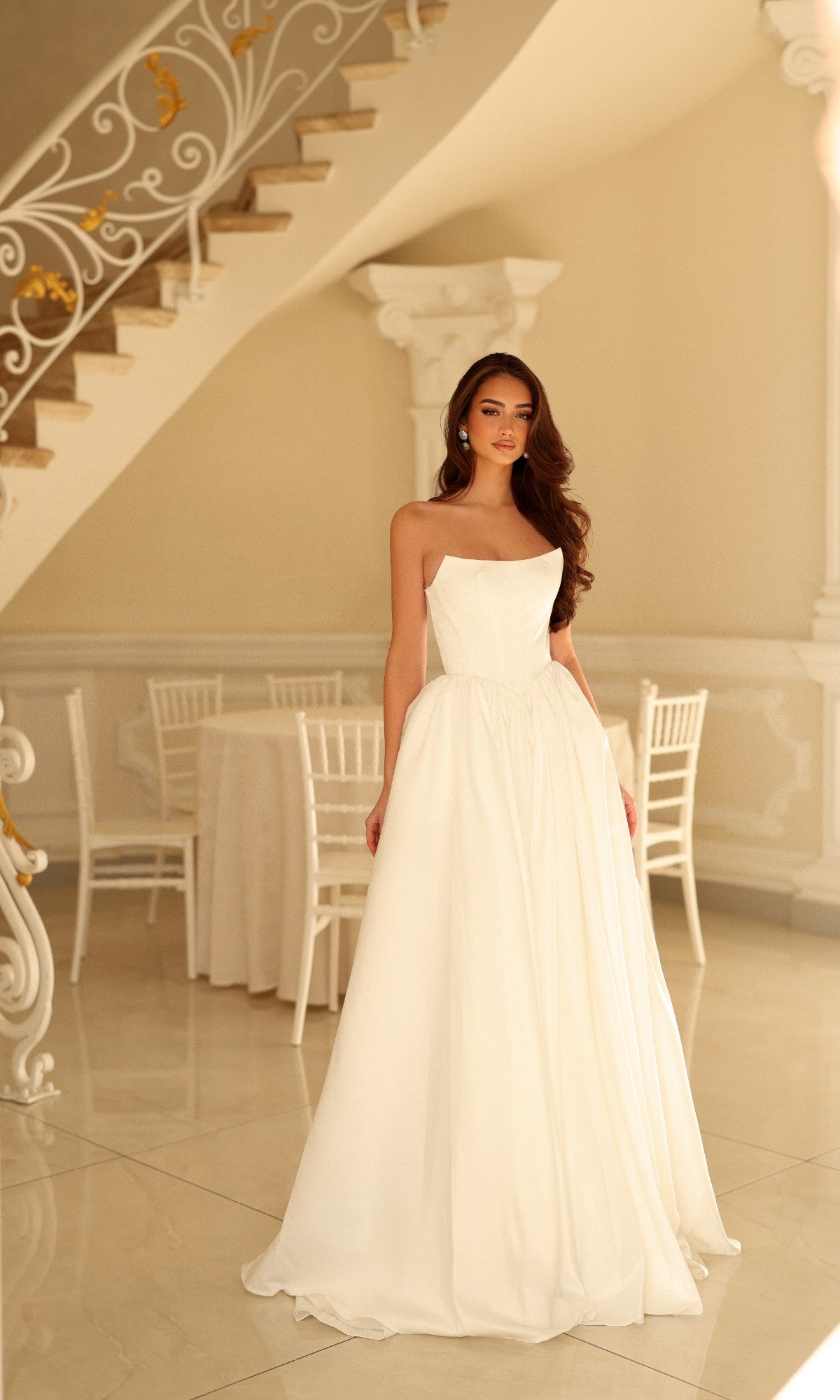 Off-white strapless A-line Tina Holly TW622 wedding dress with a fitted bodice and a full-length skirt.