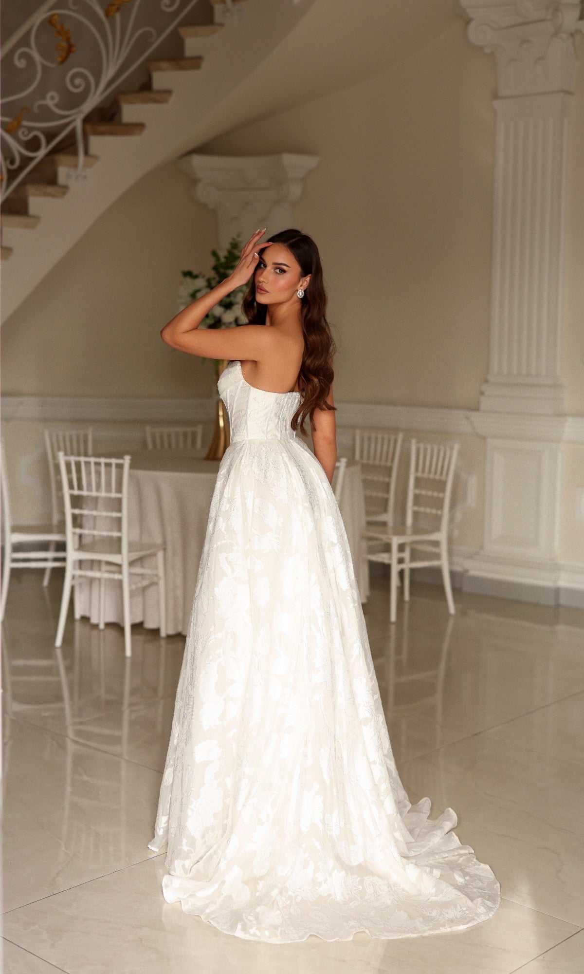 Tina Holly TW623 strapless, floor-length A-line bridal gown in organza jacquard with a floral pattern and a small train.