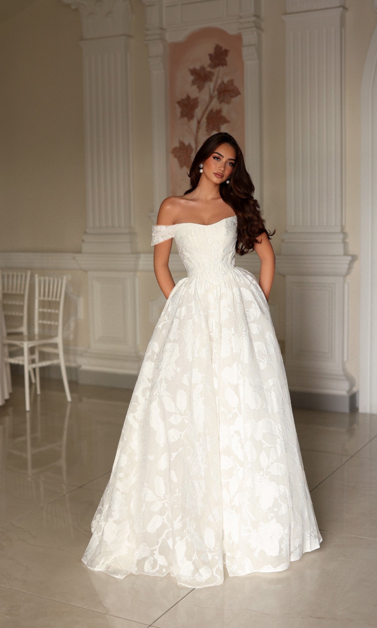 Tina Holly TW627 floor-length off-the-shoulder A-line wedding dress with a sweetheart neckline and a full organza jacquard skirt featuring a subtle floral pattern.