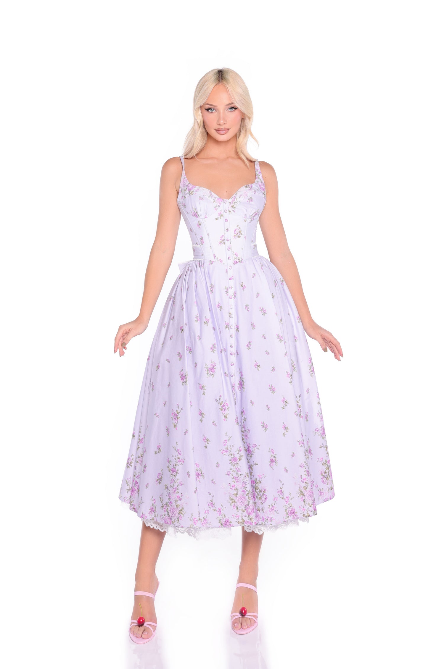 A woman stands against a white background wearing the Violetta Lilac Purple Midi Casual Dress with Bow and pink open-toe heels.