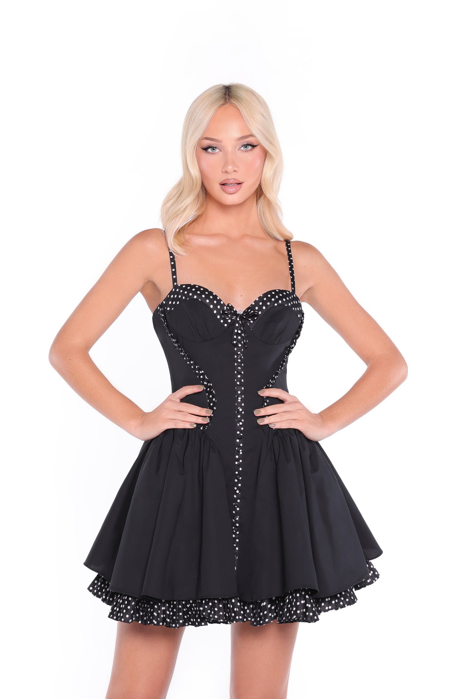 Model wears the Black Polka Dot Short Casual Dress: Vivienne, standing with hands on hips against a plain white background.