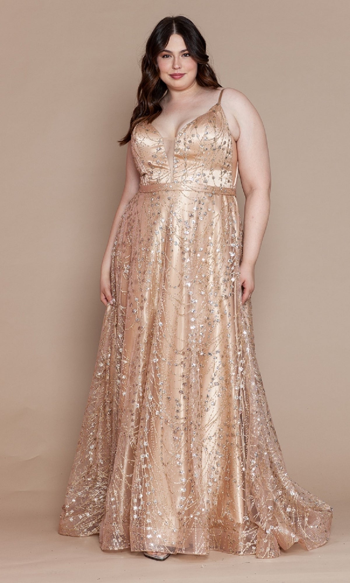 A woman stands against a beige background in the gold Plus-Size Long Glitter-Print Prom Dress W1004, featuring a floor-length silhouette, sleeveless design, deep V-neckline, and sparkling sequin details.
