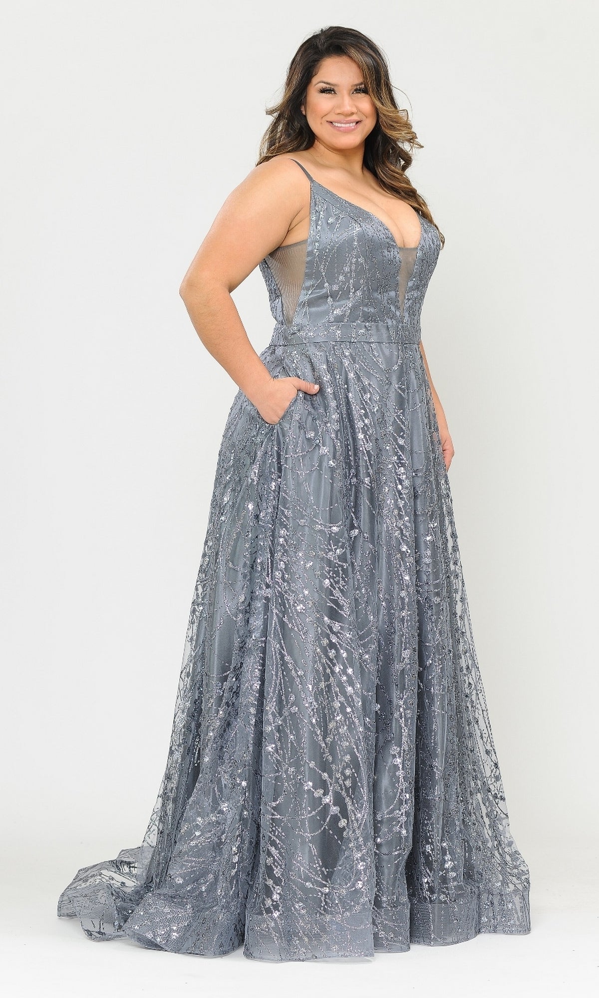 A woman models the Plus-Size Long Glitter-Print Prom Dress W1004—a sleeveless, silver-grey evening gown with a V-neckline, floor-length hem, and pockets—posing against a plain background.