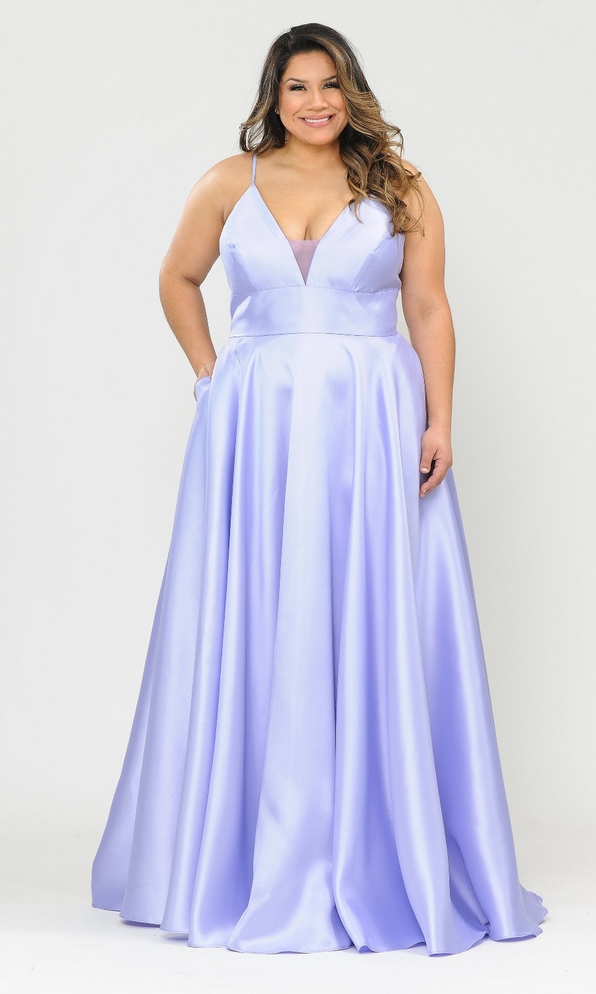A woman in the Plus-Size Long Corset Prom Dress with Pockets W1070, a floor-length lilac gown with a deep V-neckline, stands against a plain white background.