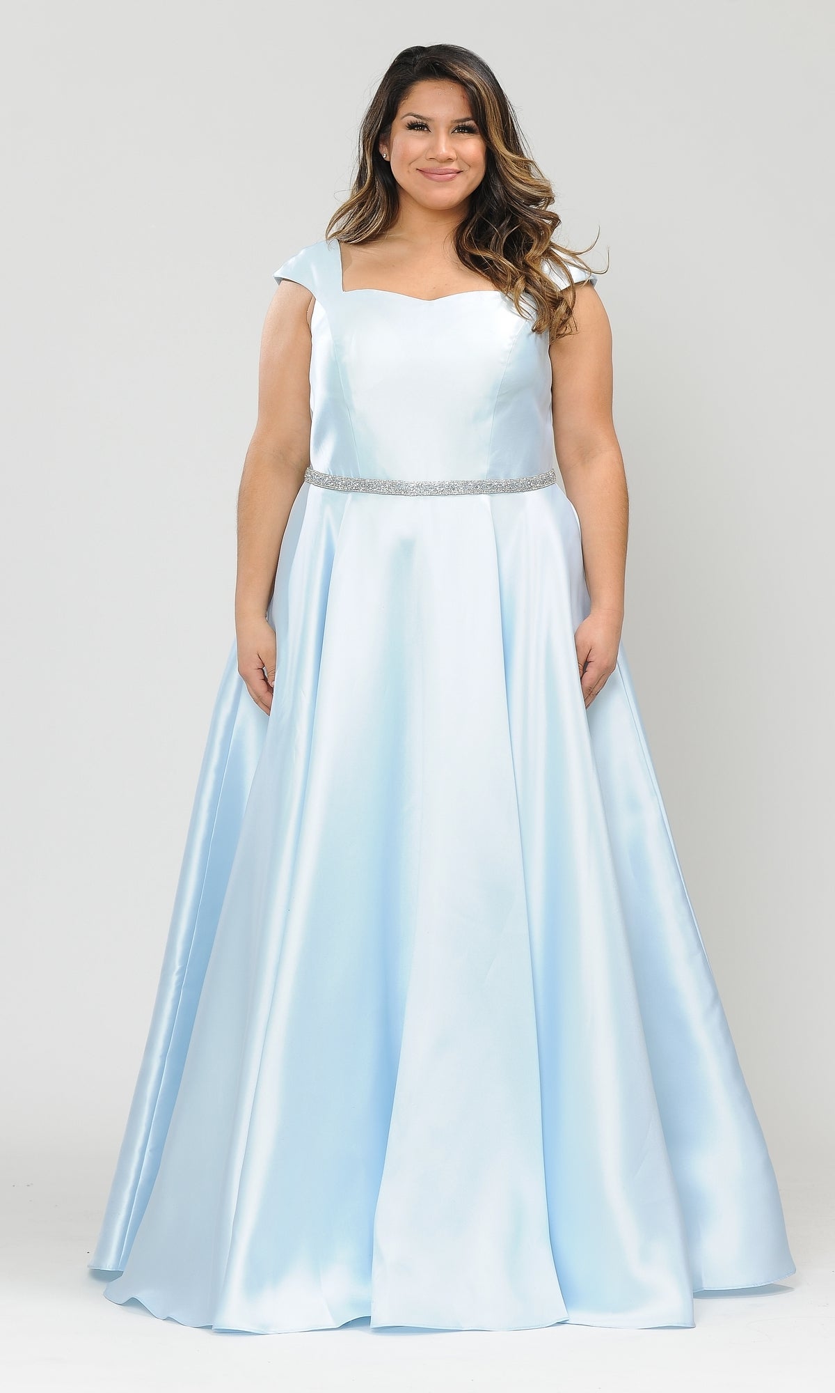 A woman wears a blue Plus-Size Cap-Sleeve Long Prom Dress W1104 featuring cap sleeves, a fitted bodice, and an elegant A-line silhouette—perfect for formal events or special occasions.