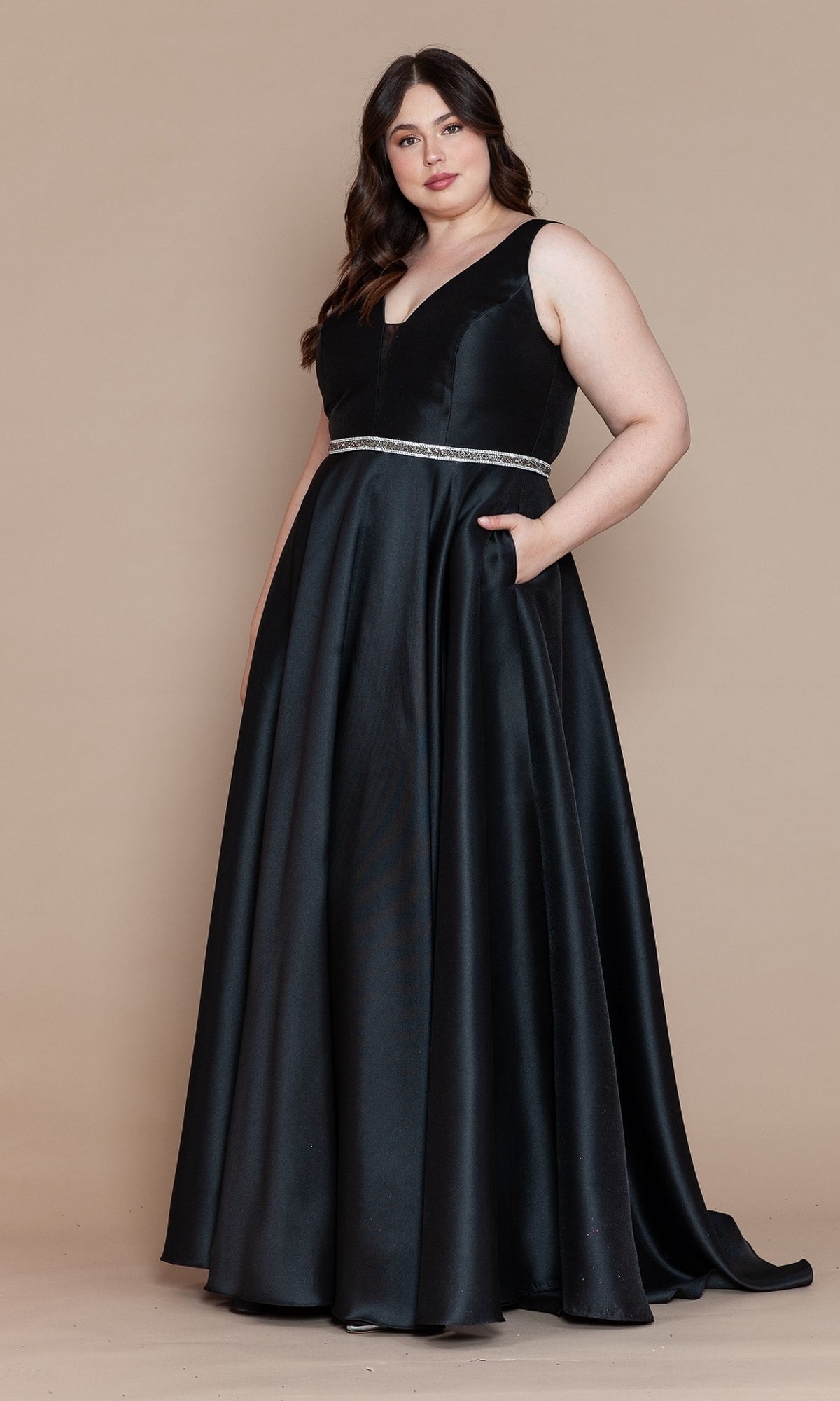A woman poses against a beige background in the V-Neck Plus-Size Long Prom Dress with Pockets W1108, featuring a sleeveless design, floor-length skirt, and subtle waistband.